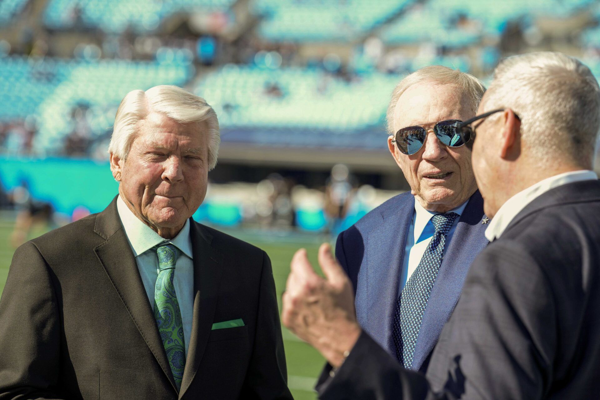 Cowboys owner Jerry Jones chats with announcer and former coach Jimmie Johnson during pregame warm ups between the Carolina Panthers and the Dallas Cowboys at Bank of America Stadium.