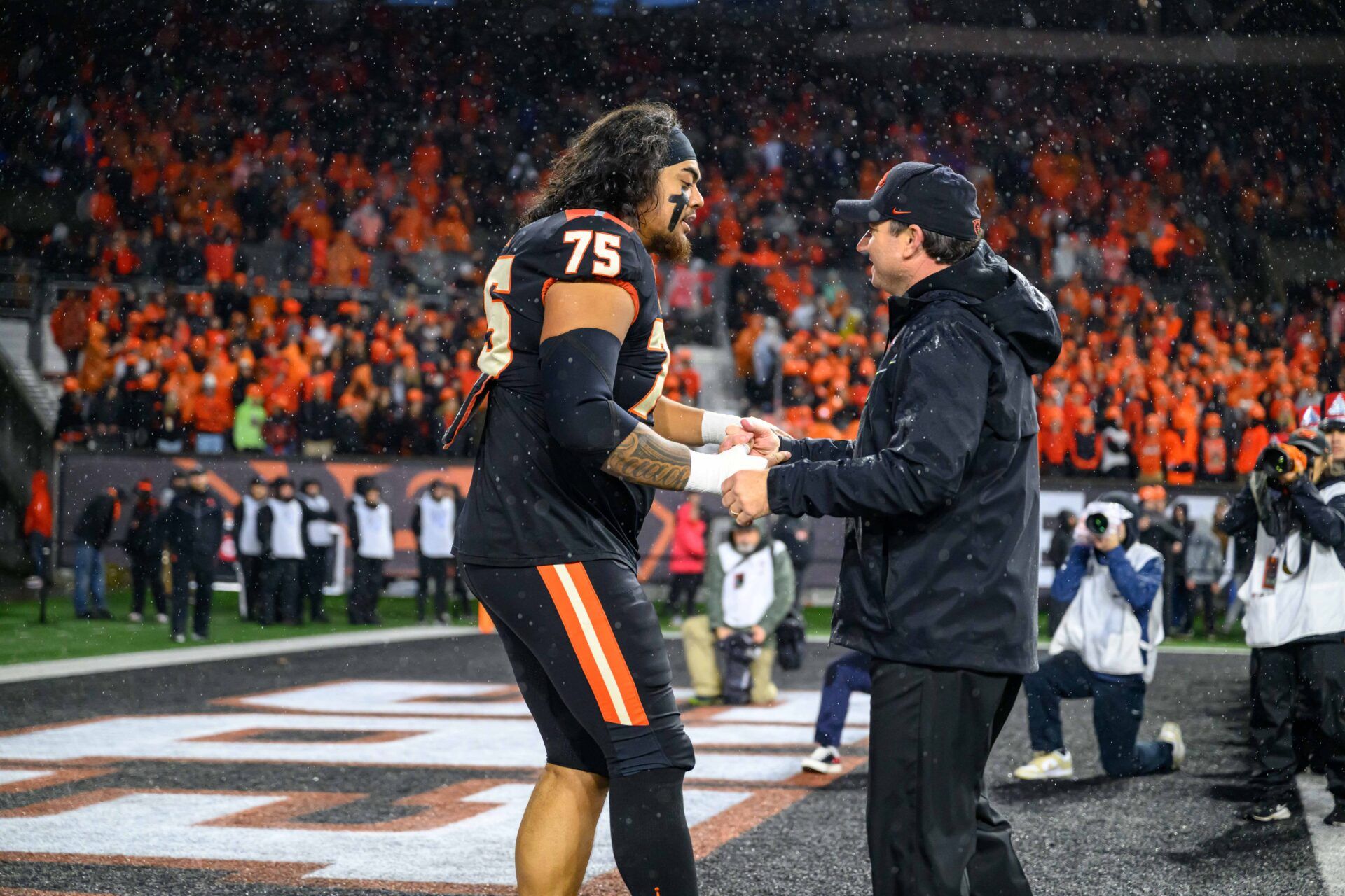 Oregon State Beavers head coach Jonathan Smith greets offensive lineman Taliese Fuaga (75) during senior ceremonies pregame against the Washington Huskies at Reser Stadium.