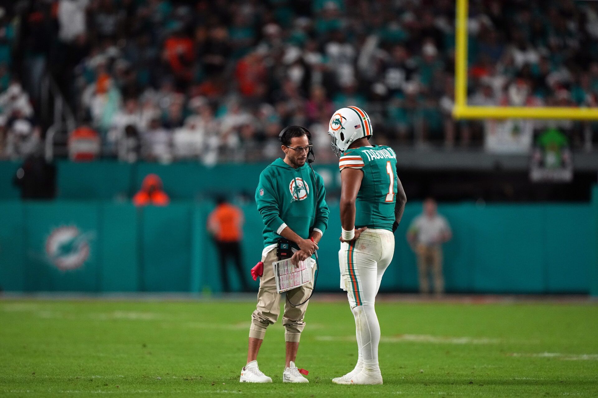 Miami Dolphins head coach Mike McDaniel talks with quarterback Tua Tagovailoa (1) during a timeout in the second half against the Dallas Cowboys at Hard Rock Stadium.