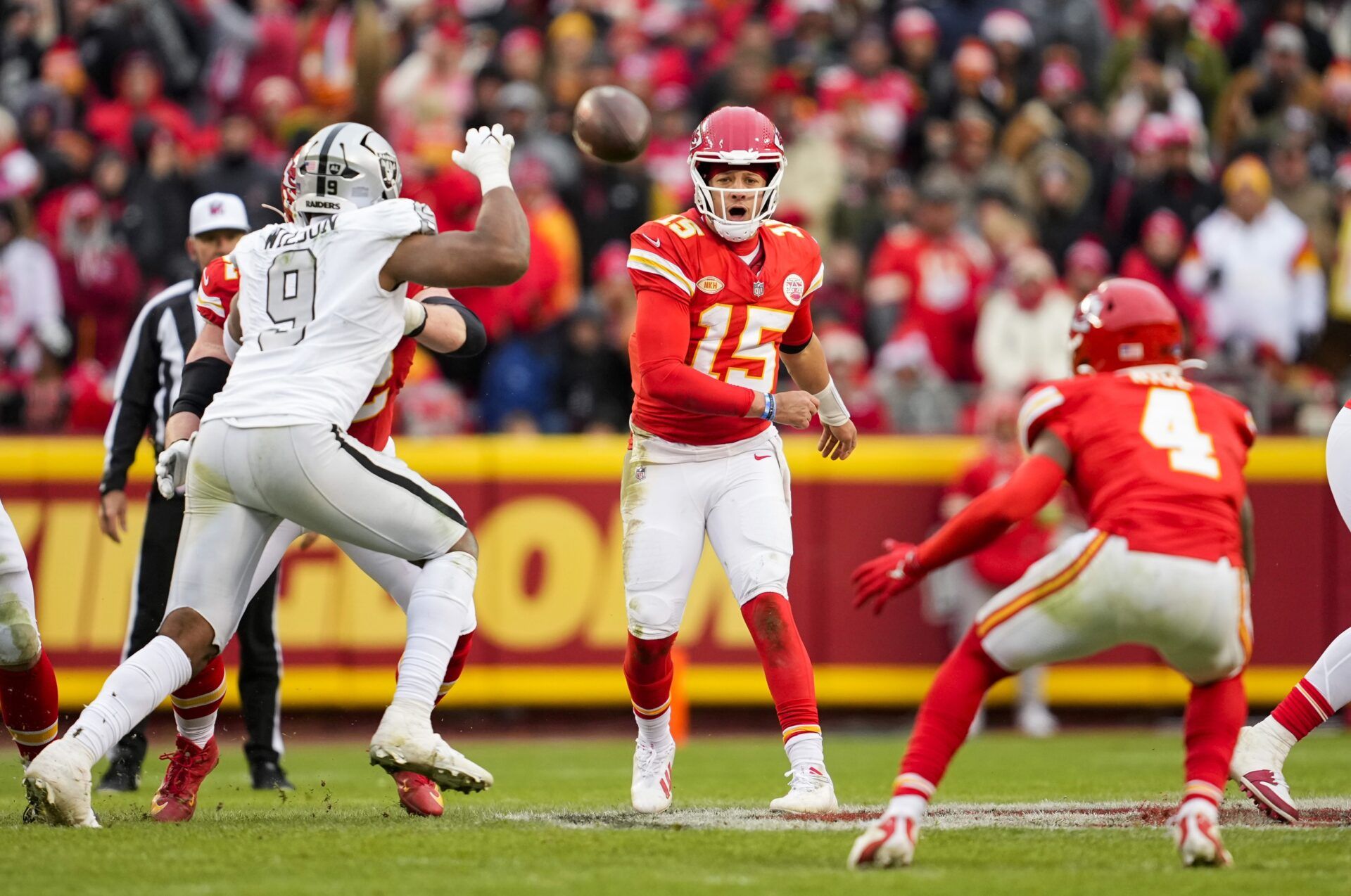 Kansas City Chiefs quarterback Patrick Mahomes (15) throws a pass against Las Vegas Raiders defensive end Tyree Wilson (9) during the second half at GEHA Field at Arrowhead Stadium.