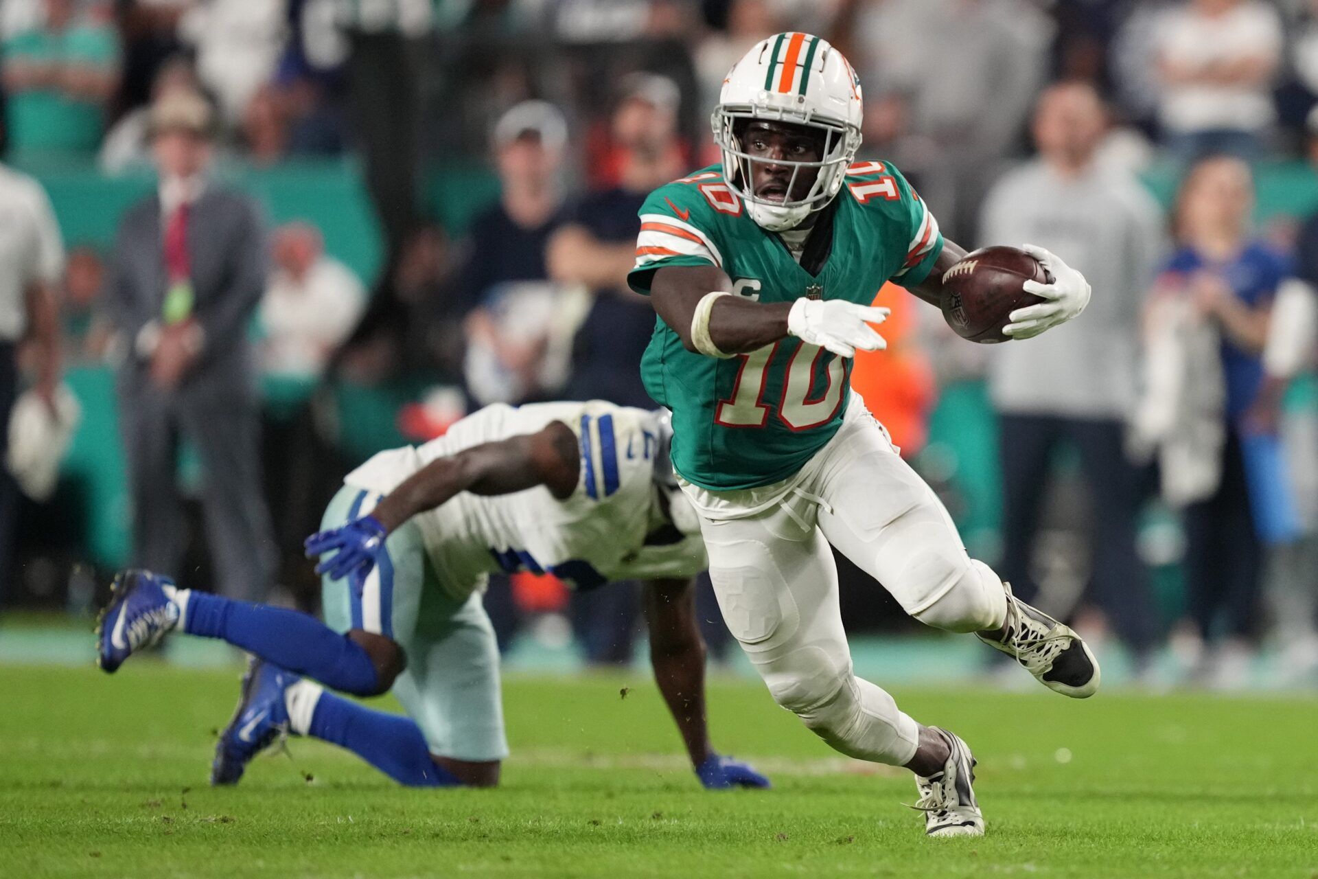 Miami Dolphins wide receiver Tyreek Hill (10) picks up a first down on the Dolphins final drive that lead to a game-winning field goal against the Dallas Cowboys during an NFL game at Hard Rock Stadium