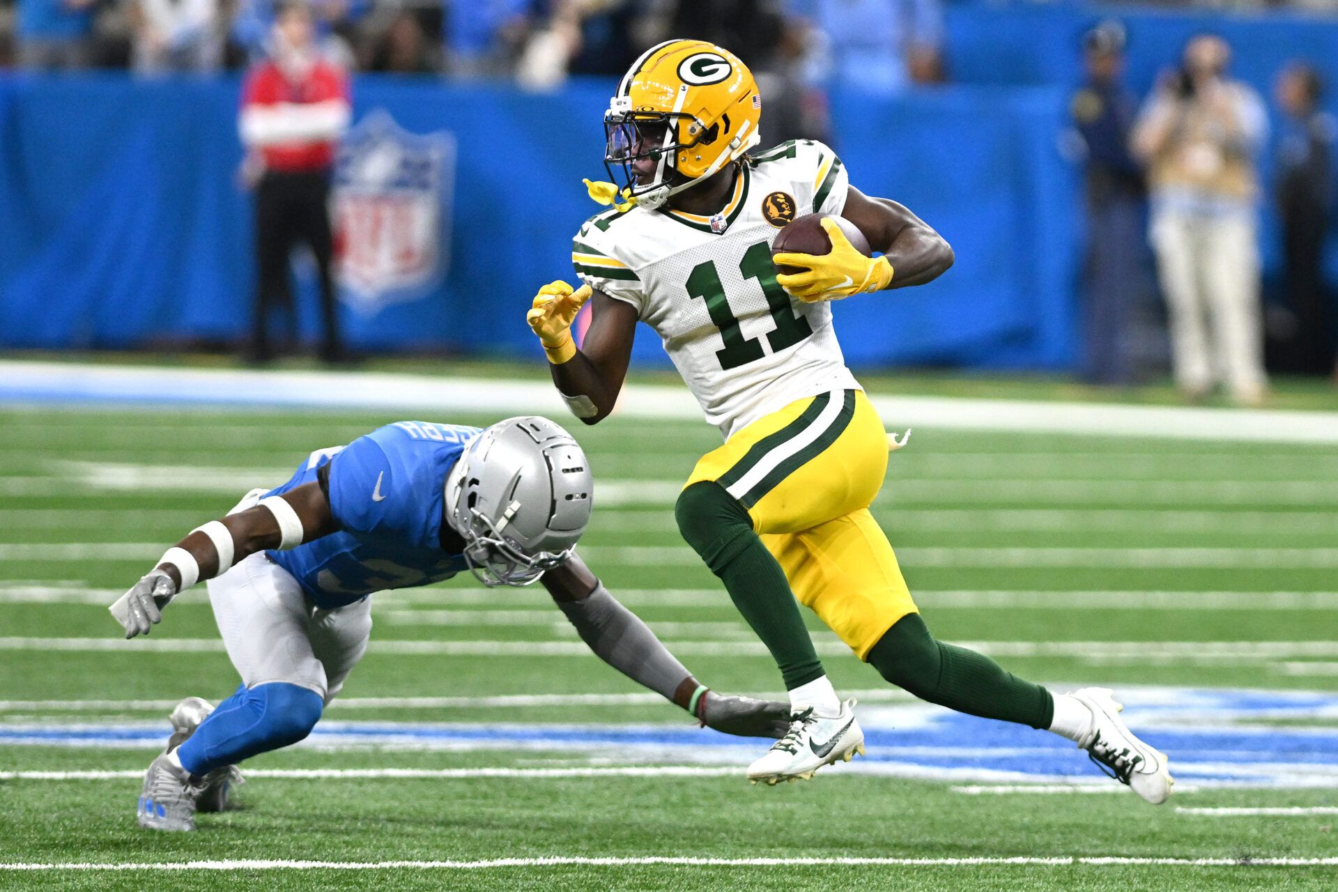 Green Bay Packers wide receiver Jayden Reed (11) runs with the ball against the Detroit Lions in the third quarter at Ford Field.