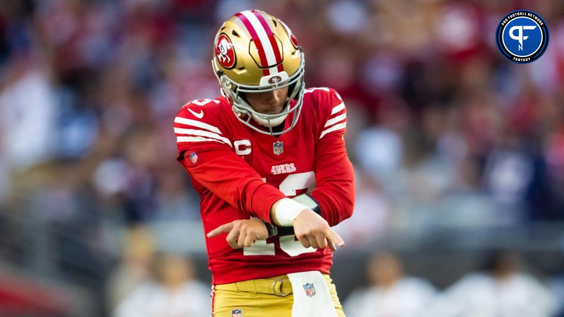 San Francisco 49ers quarterback Brock Purdy (13) celebrates a touchdown against the Arizona Cardinals at State Farm Stadium.