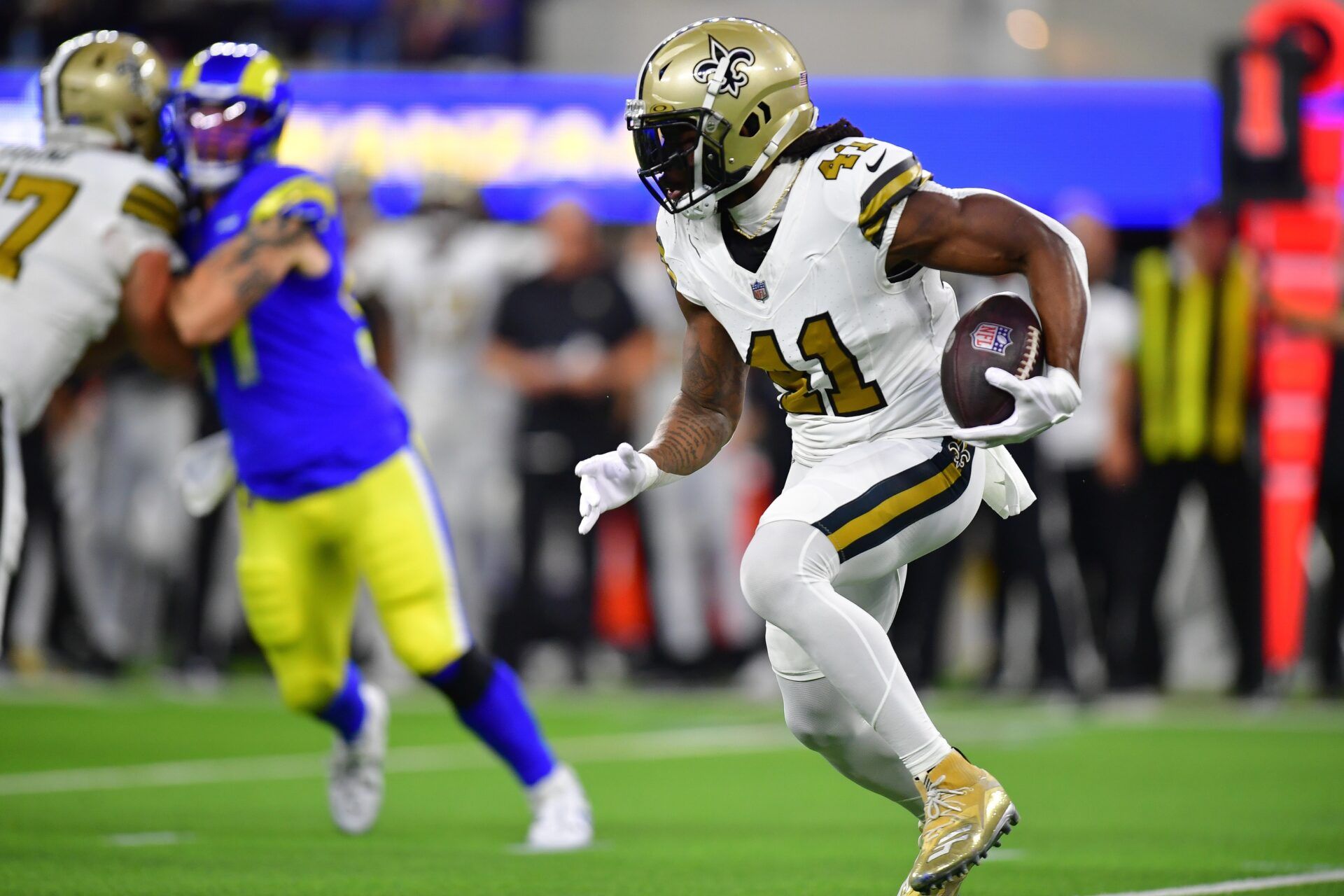 New Orleans Saints running back Alvin Kamara (41) runs the ball against the Los Angeles Rams during the first half at SoFi Stadium.