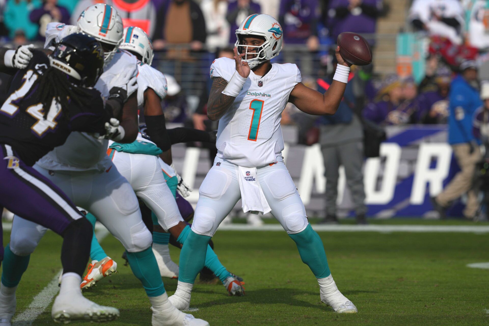 Miami Dolphins QB Tua Tagovailoa (1) throws a pass against the Baltimore Ravens.