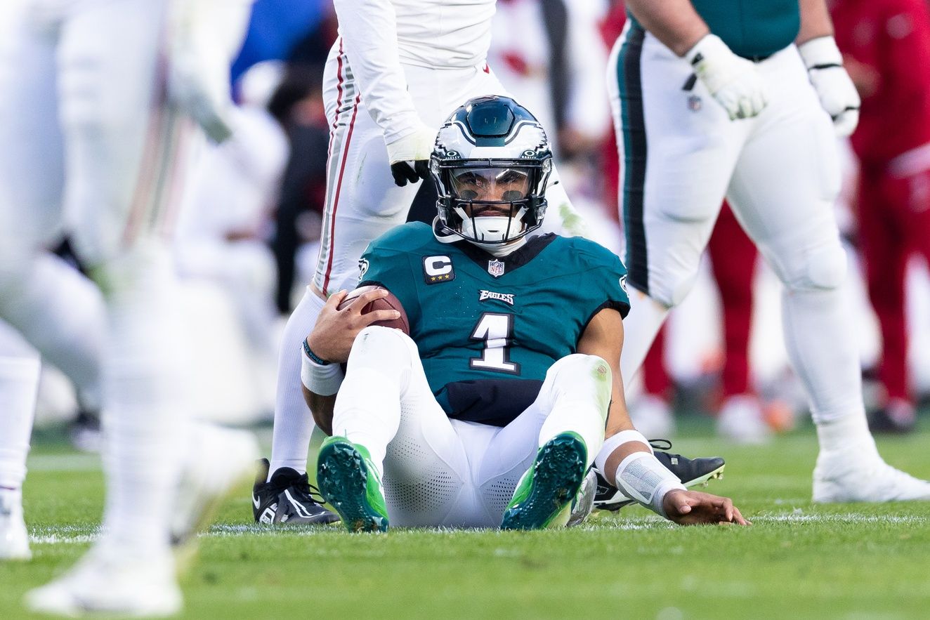 Philadelphia Eagles quarterback Jalen Hurts (1) sits on the field after being tackled during the fourth quarter against the Arizona Cardinals at Lincoln Financial Field.