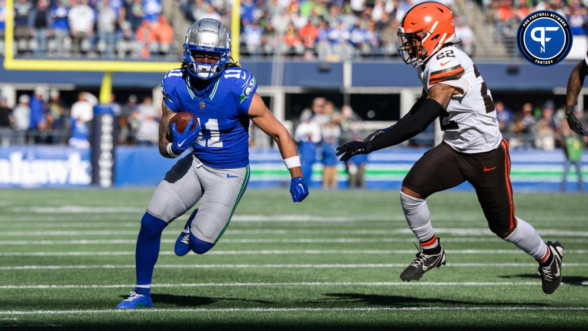 Seattle Seahawks wide receiver Jaxon Smith-Njigba (11) carries the ball after a catch while chased by Cleveland Browns safety Grant Delpit (22) at Lumen Field.