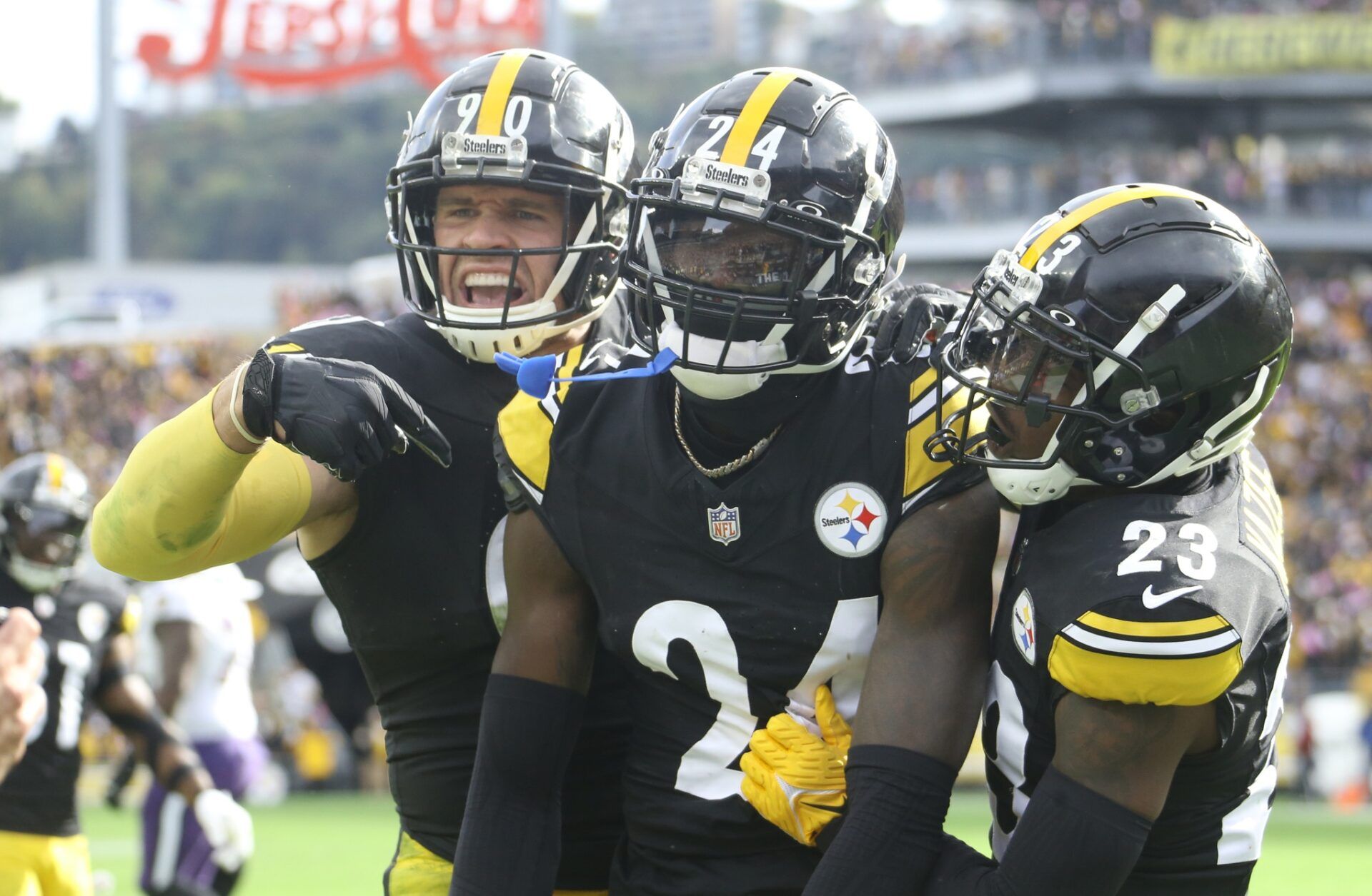 Pittsburgh Steelers defensive players celebrate after an interception against the Baltimore Ravens.