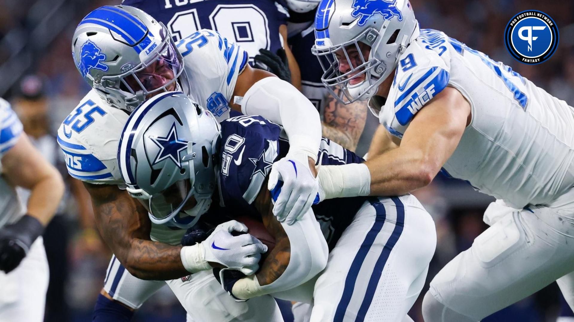 Dallas Cowboys running back Tony Pollard (20) is tackled by Detroit Lions defensive end John Cominsky (79) and Detroit Lions linebacker Derrick Barnes (55) during the first half at AT&T Stadium.