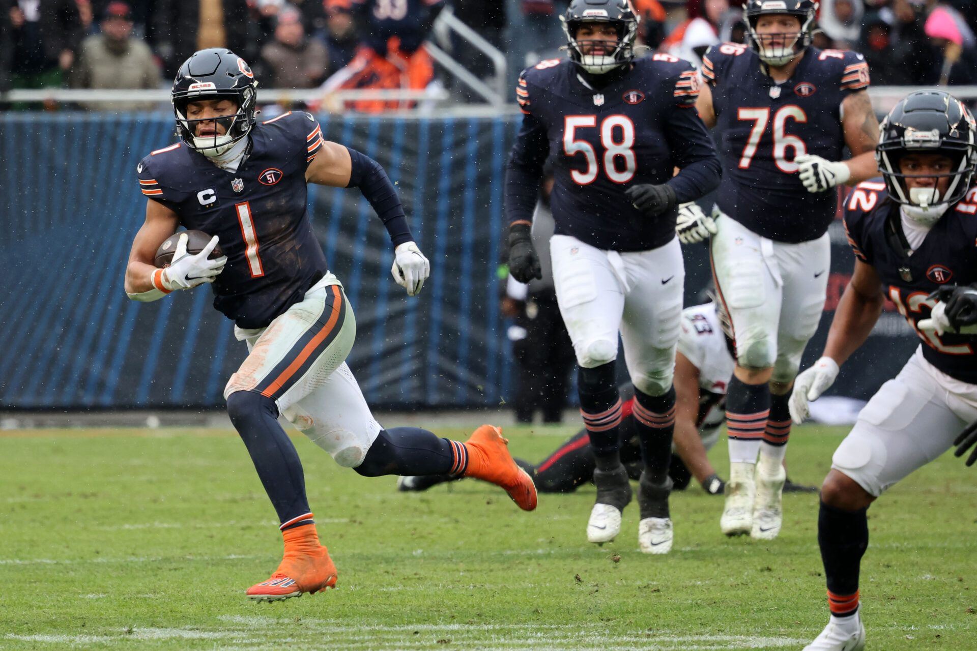 Chicago Bears quarterback Justin Fields (1) rushes the ball against the Atlanta Falcons during the second half at Soldier Field.