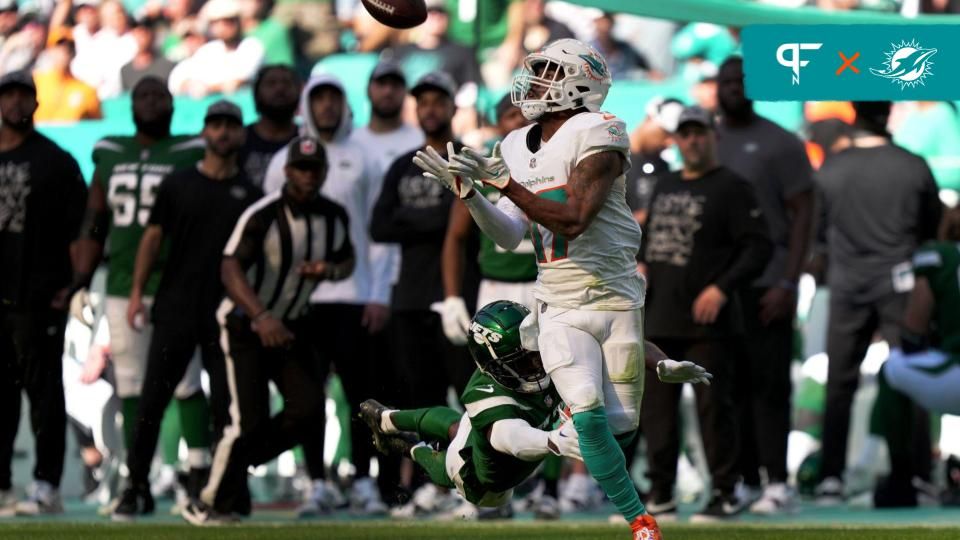 Jaylen Waddle (17) catches a pass over New York Jets cornerback D.J. Reed (4) for a touchdown during the first half of an NFL game at Hard Rock Stadium.