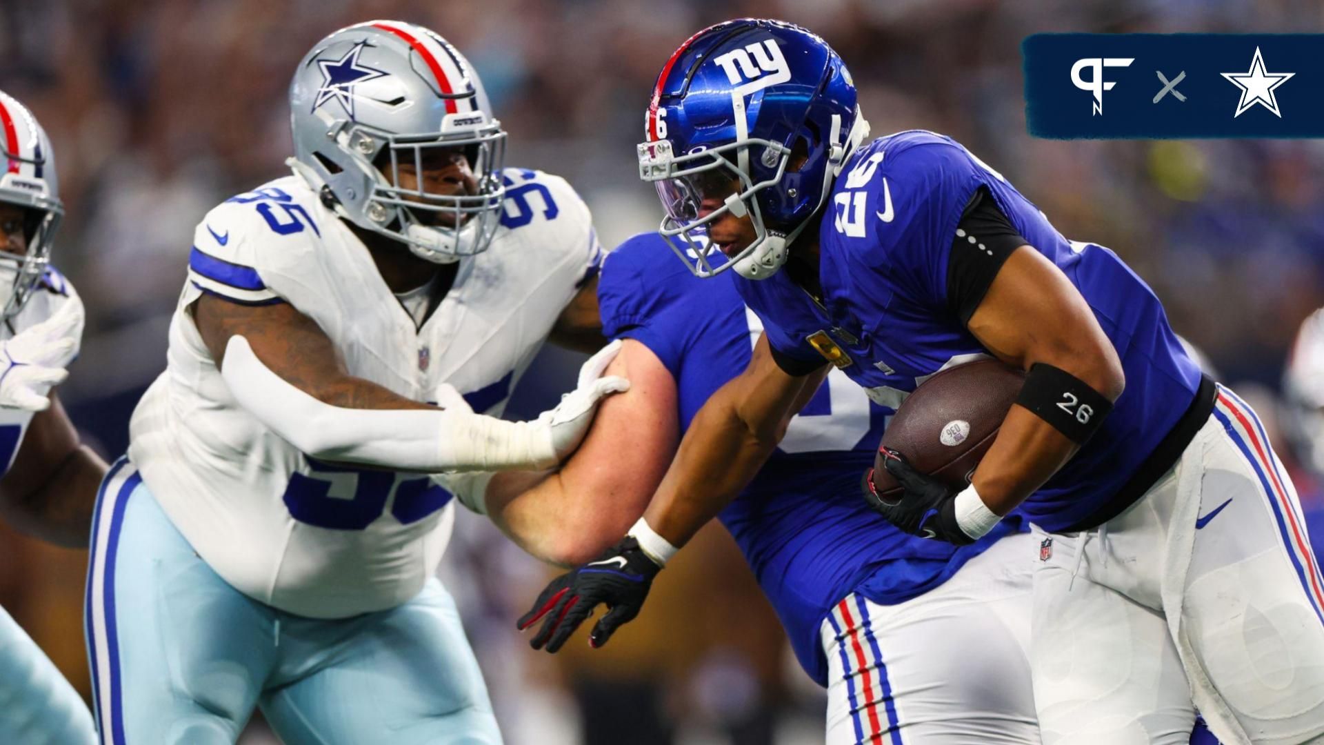 New York Giants running back Saquon Barkley (26) runs with the ball as Dallas Cowboys defensive tackle Johnathan Hankins (95) defends during the first quarter at AT&T Stadium.