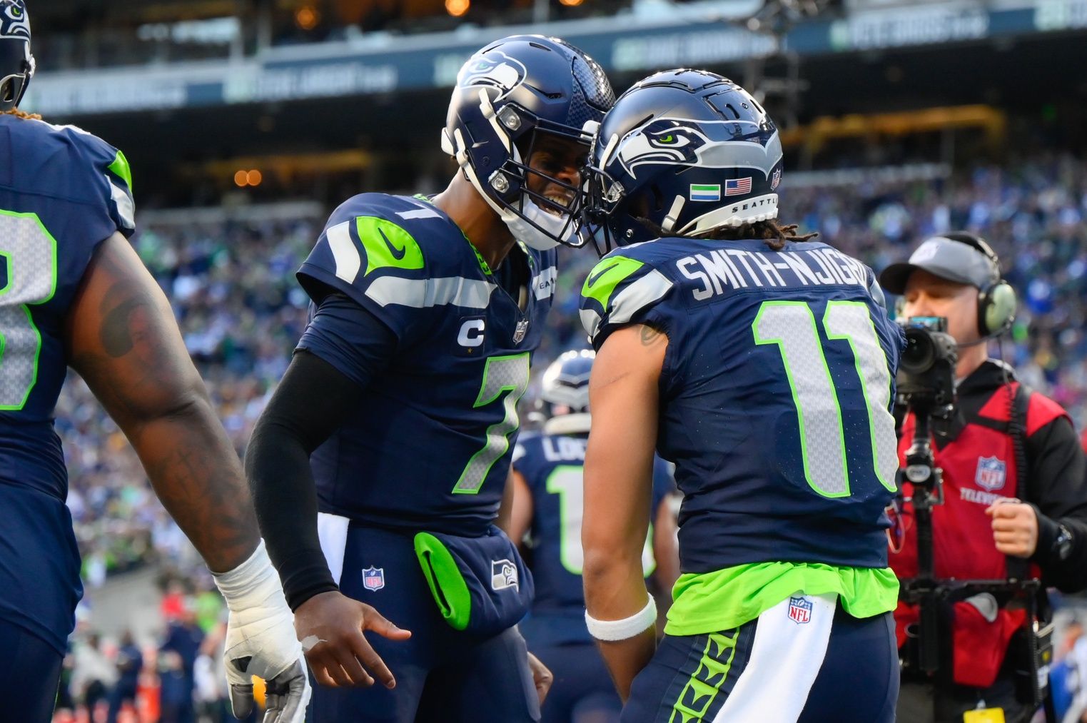 Seattle Seahawks quarterback Geno Smith (7) and wide receiver Jaxon Smith-Njigba (11) celebrate after Jaxon Smith-Njigba caught a pass for a touchdown against the Pittsburgh Steelers during the first half at Lumen Field.