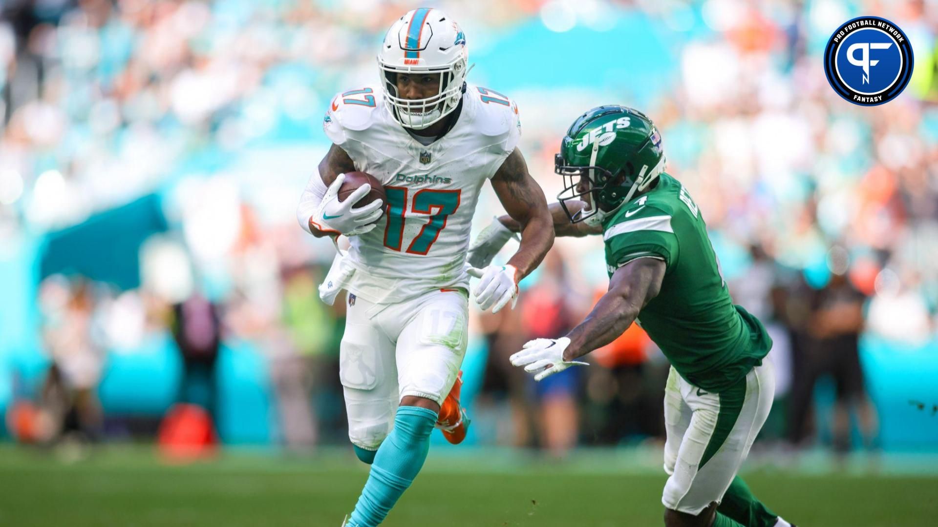 Miami Dolphins wide receiver Jaylen Waddle (17) runs with the football past New York Jets cornerback D.J. Reed (4) during the second quarter at Hard Rock Stadium.