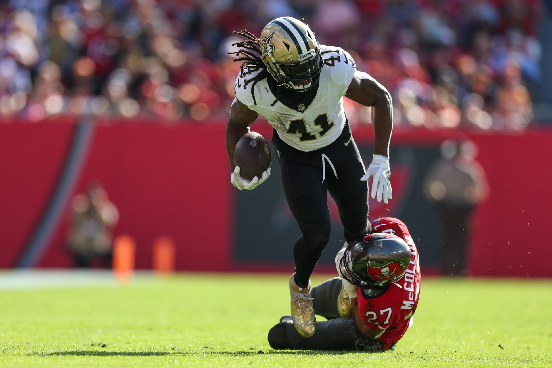 New Orleans Saints running back Alvin Kamara (41) is brought down by Tampa Bay Buccaneers cornerback Zyon McCollum (27) in the second quarter at Raymond James Stadium.