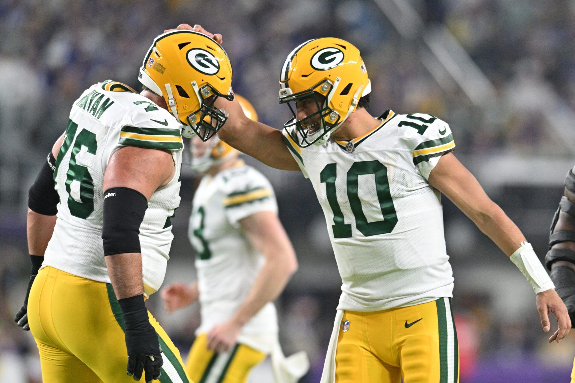 Green Bay Packers quarterback Jordan Love (10) and guard Jon Runyan (76) react after a touchdown by Love against the Minnesota Vikings during the second quarter at U.S. Bank Stadium.