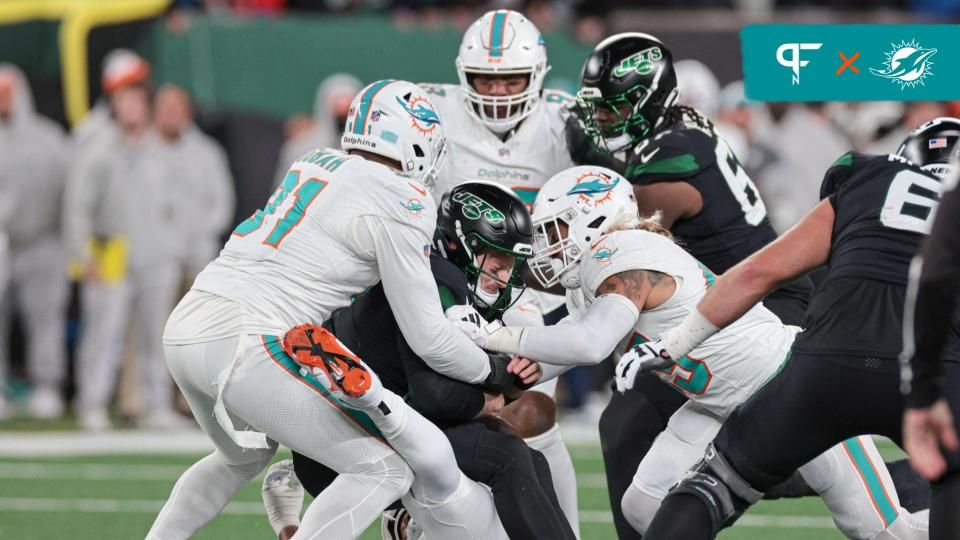 New York Jets guard Laken Tomlinson (78) is sacked by Miami Dolphins defensive tackle Raekwon Davis (98), defensive tackle Da'Shawn Hand (93) and defensive end Emmanuel Ogbah (91) during the second half at MetLife Stadium.