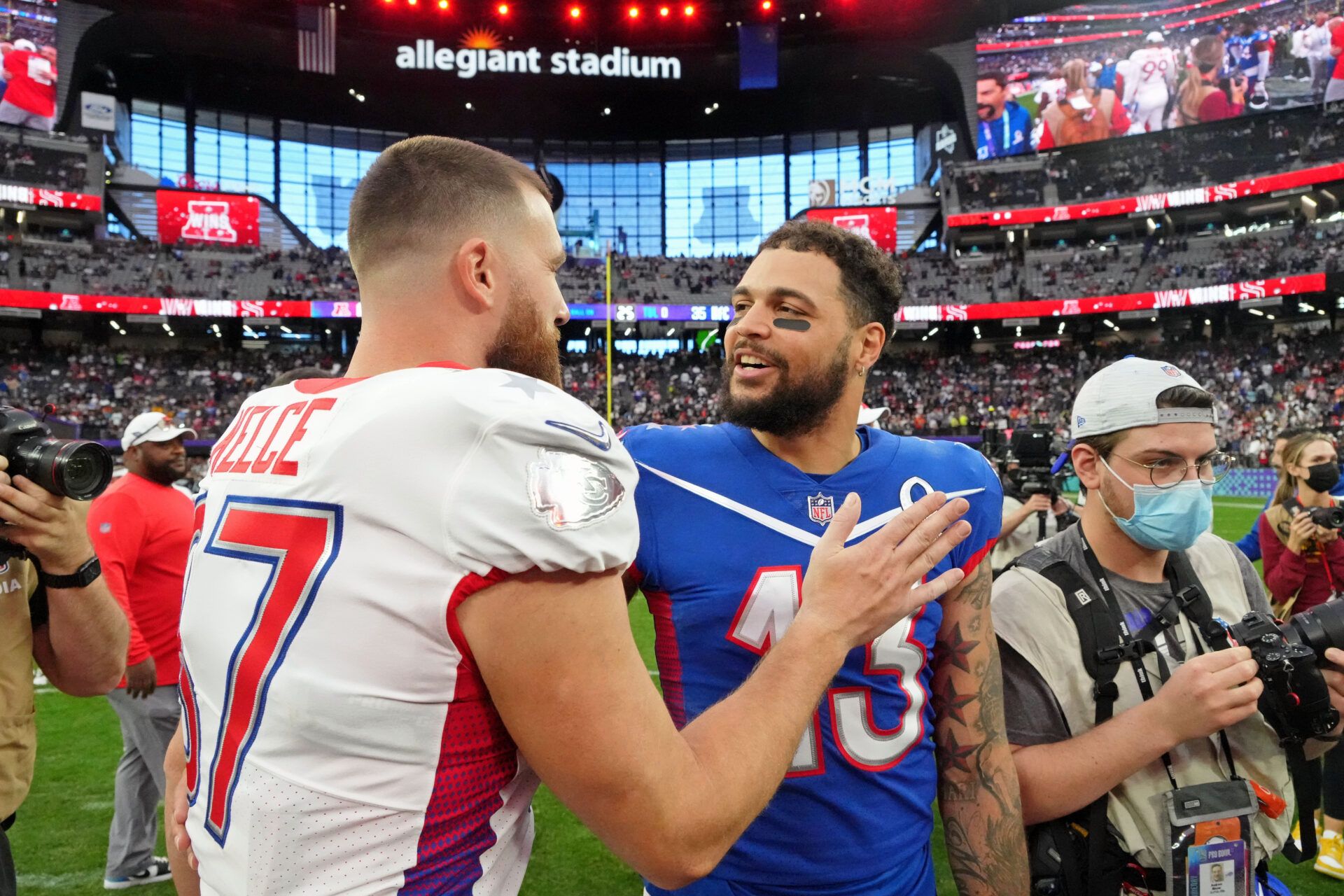 AFC tight end Travis Kelce of the Kansas City Chiefs (87) talks with NFC wide receiver Mike Evans of the Tampa Bay Buccaneers (13) after the Pro Bowl football game at Allegiant Stadium.