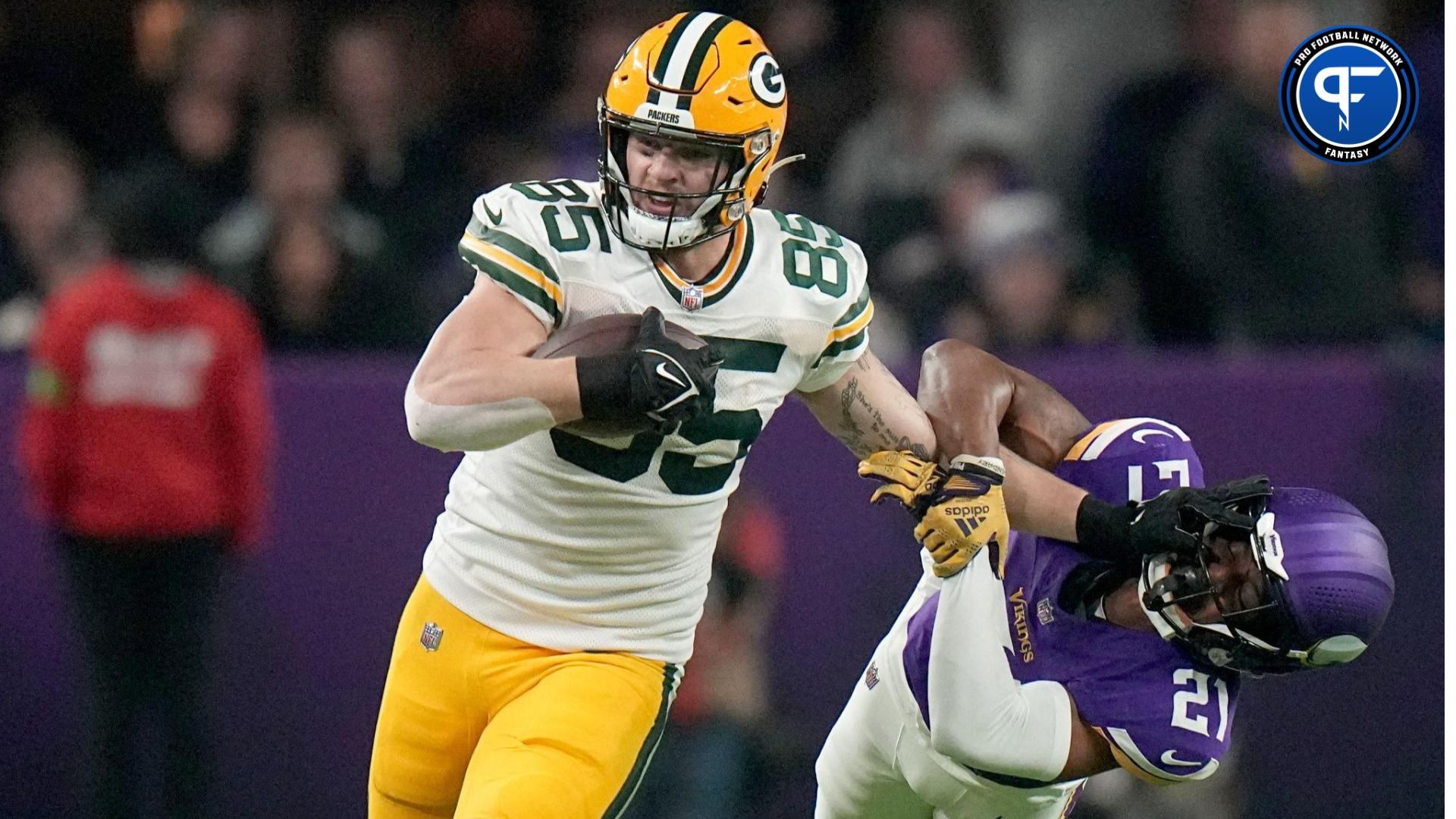 Green Bay Packers tight end Tucker Kraft (85) stiff-arms Minnesota Vikings cornerback Akayleb Evans (21) on. 13-yard reception during the first quarter of their game at U.S. Bank Stadium.