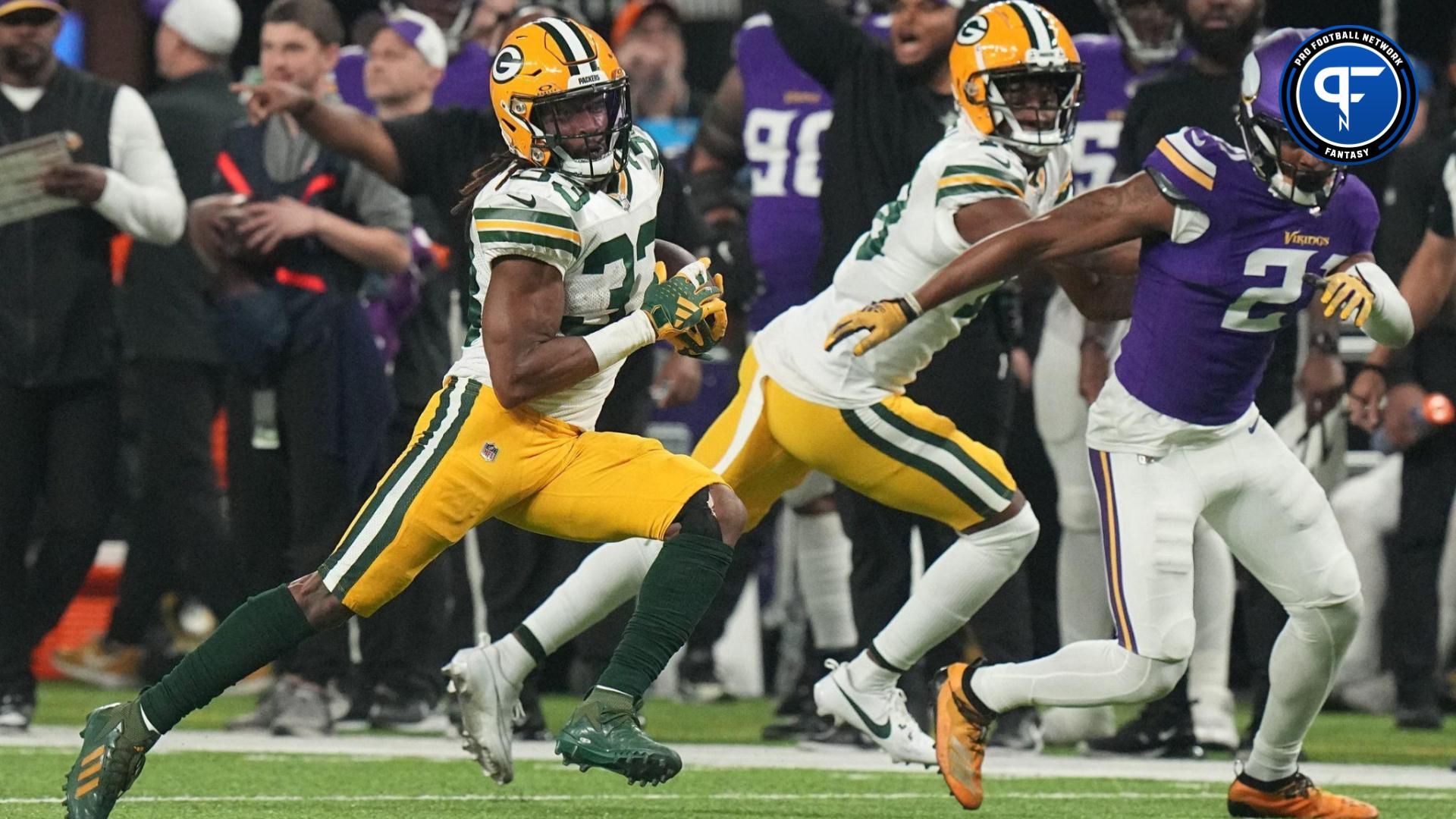 Green Bay Packers running back Aaron Jones (33) picks up 19y and on a run during the first quarter of their game Sunday, December 31, 2023 at U.S. Bank Stadium in Minneapolis, Minnesota. The Green Bay Packers beat the Minnesota Vikings 33-10.