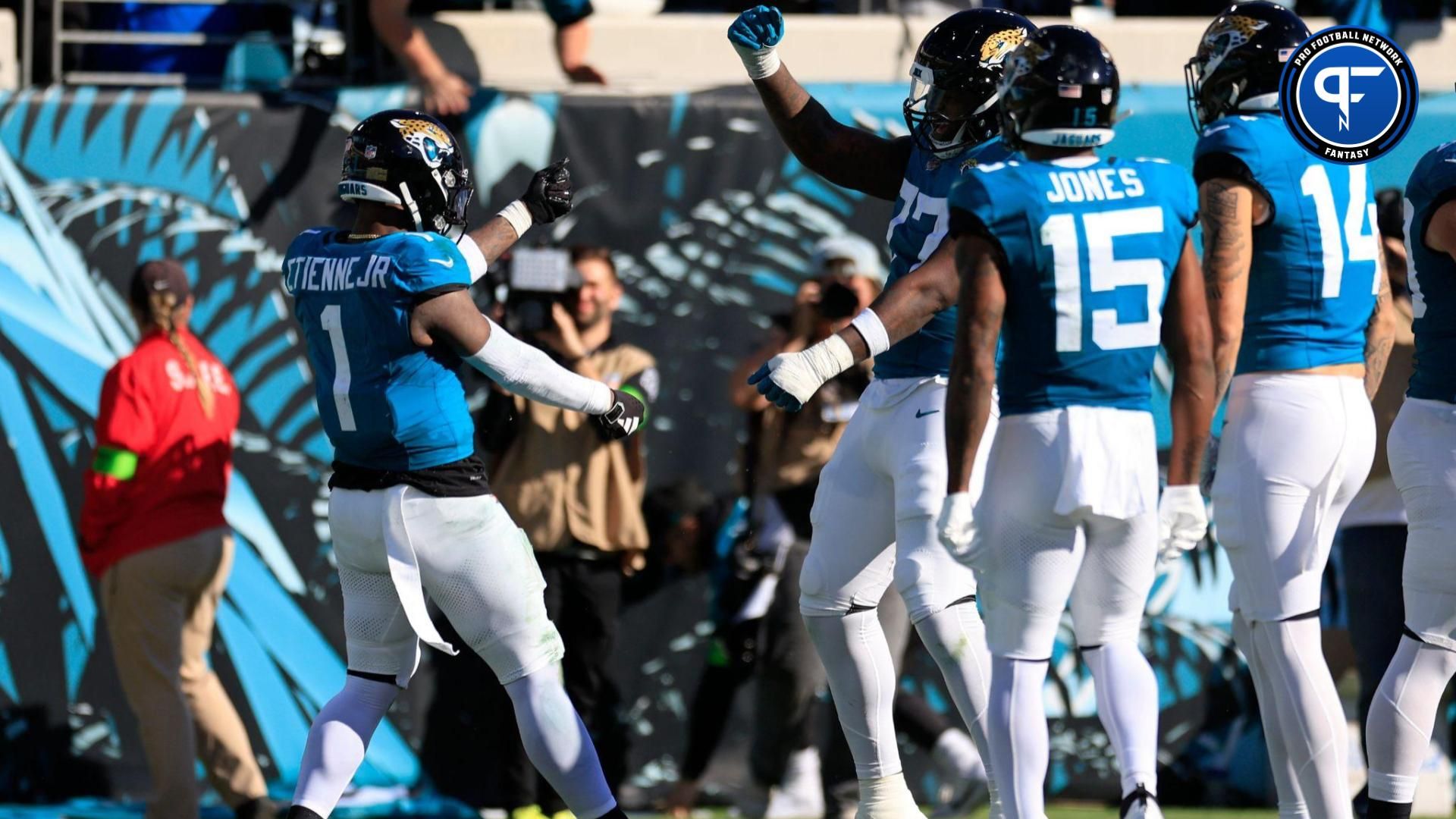 Jacksonville Jaguars running back Travis Etienne Jr. (1) celebrates his touchdown score with offensive tackle Anton Harrison (77) during the third quarter of a regular season NFL football matchup Sunday, Dec. 31, 2023 at EverBank Stadium in Jacksonville, Fla.