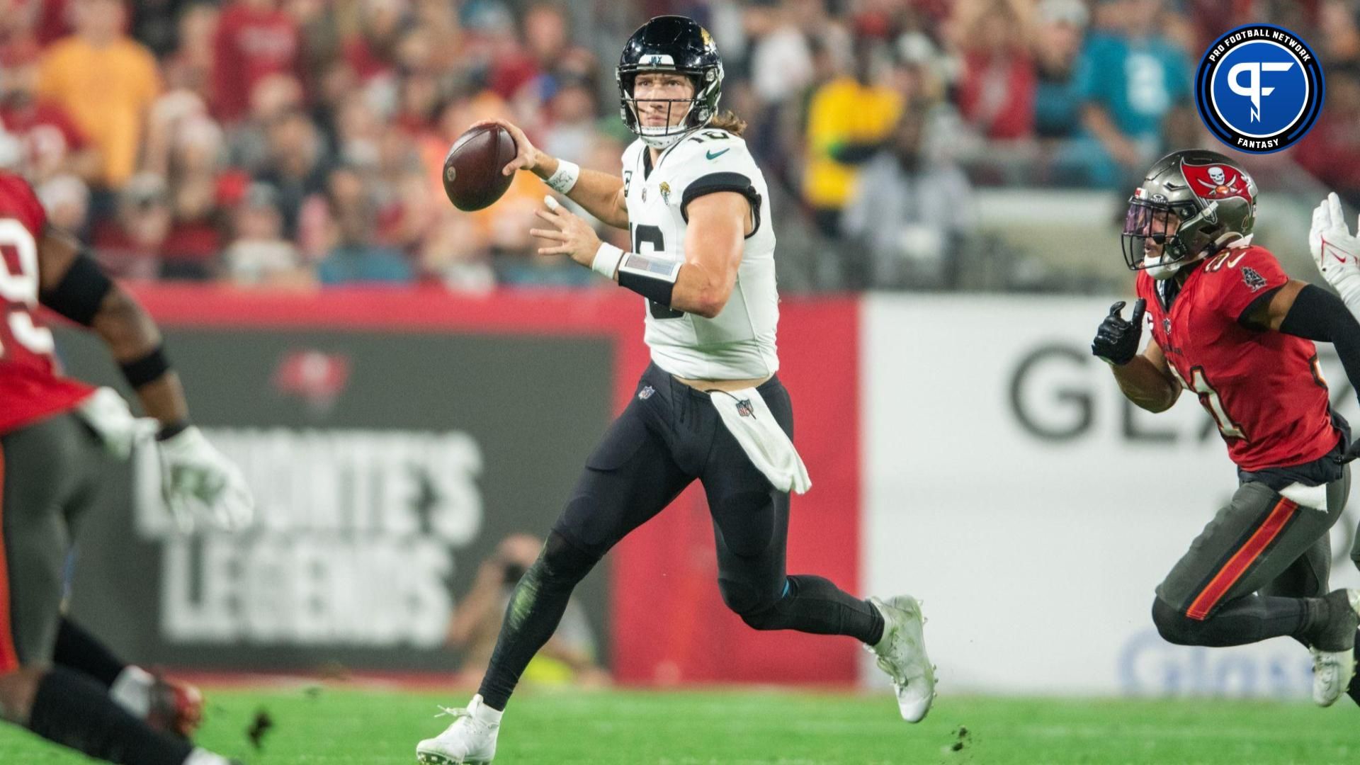 Jacksonville Jaguars quarterback Trevor Lawrence (16) runs the ball against the Tampa Bay Buccaneers in the third quarter at Raymond James Stadium.