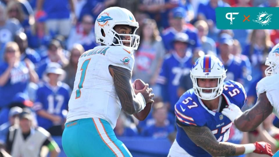 Miami Dolphins quarterback Tua Tagovailoa (1) looks to throw a pass as Buffalo Bills defensive end AJ Epenesa (57) rushes in during the fourth quarter at Highmark Stadium.