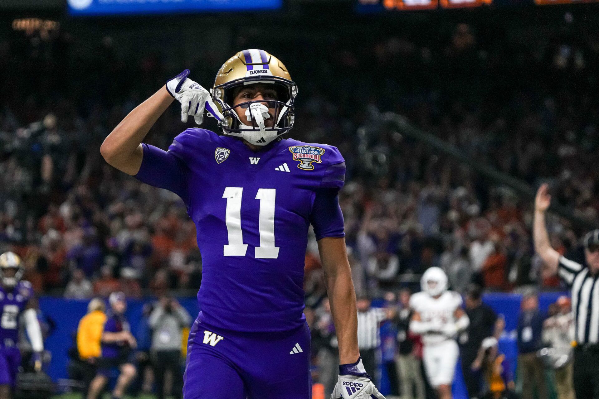 Washington wide receiver Jalen McMillan (11) mocks Texas fans with the \