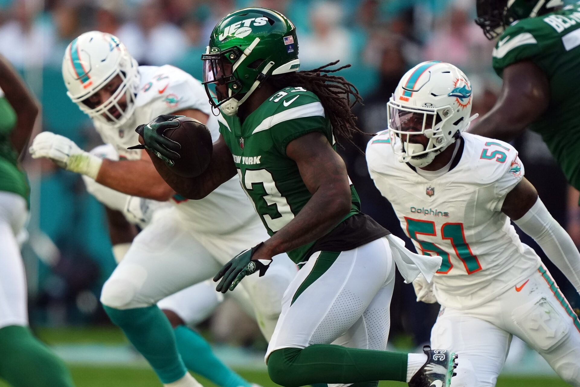 New York Jets running back Dalvin Cook (33) rushes with the ball against the Miami Dolphins during the first half at Hard Rock Stadium.