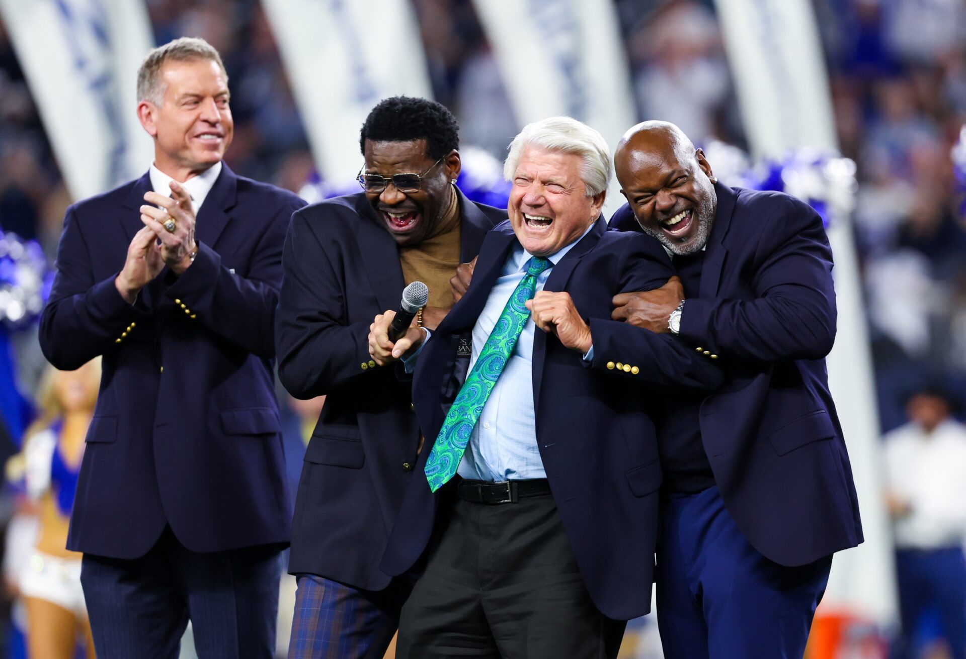 Dallas Cowboys former head coach Jimmy Johnson celebrates with former players Michael Irvin and Emmitt Smith and Troy Aikman after being inducted into the ring of honor at halftime of the game against the Detroit Lions.