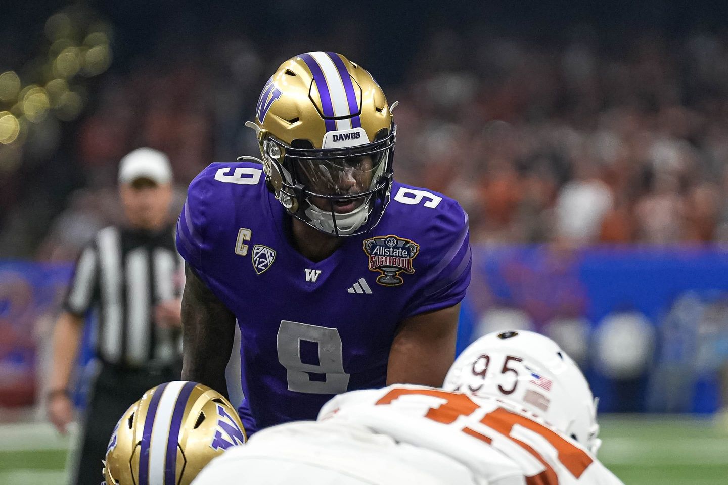 Washinton quarterback Michael Penix Jr. (9) lines up for a snap during the Sugar Bowl College Football Playoff semifinals game against the Texas Longhorns at the Caesars Superdome on Monday, Jan. 1, 2024 in New Orleans, Louisiana.