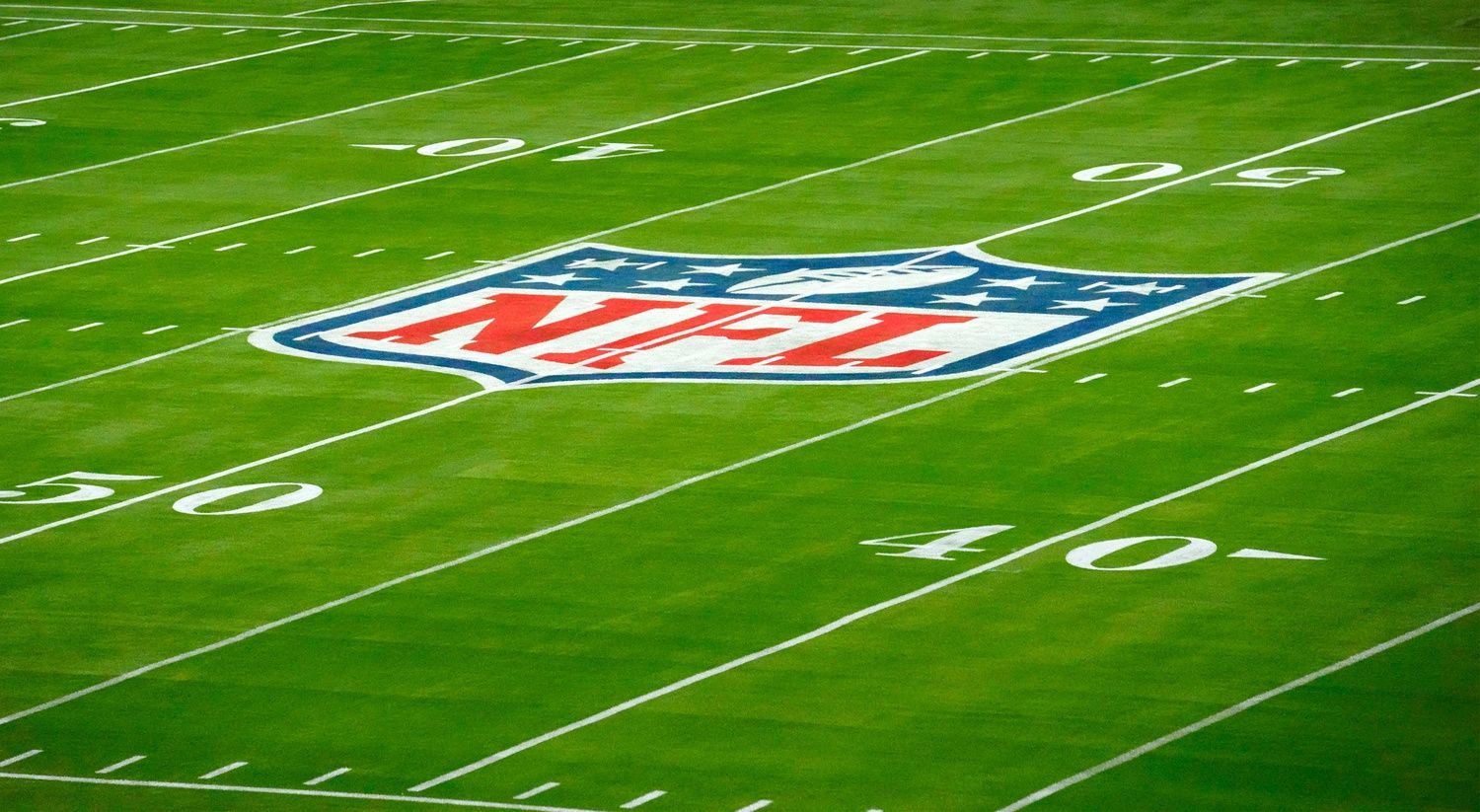 NFL logo on football field.