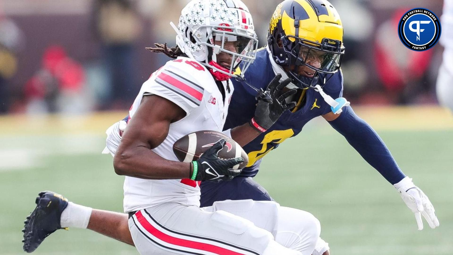 Ohio State Buckeyes WR Marvin Harrison (18) looks to make a move after a catch against the Michigan Wolverines.