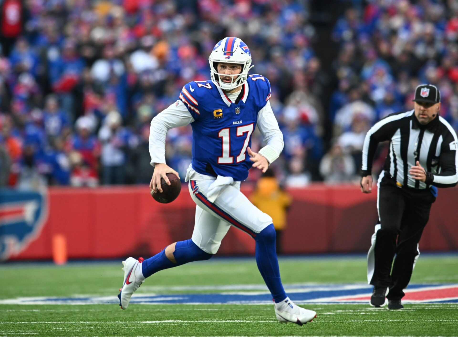 Buffalo Bills quarterback Josh Allen (17) runs out of the pocket against the New England Patriots in the first quarter at Highmark Stadium.