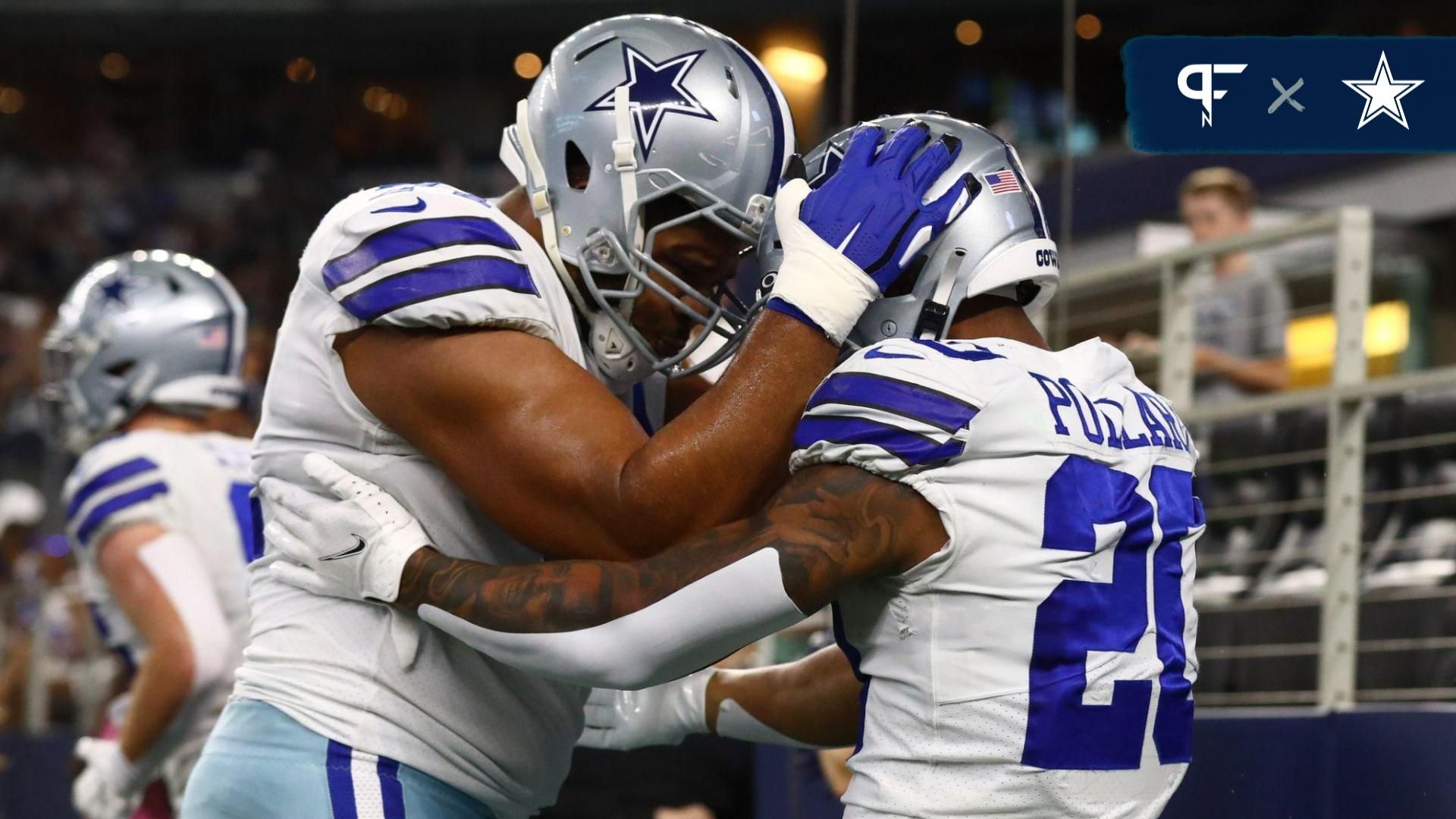 Dallas Cowboys running back Tony Pollard (20) celebrates a first quarter touchdown with tackle La'el Collins (71) against the Houston Texans at AT&T Stadium.