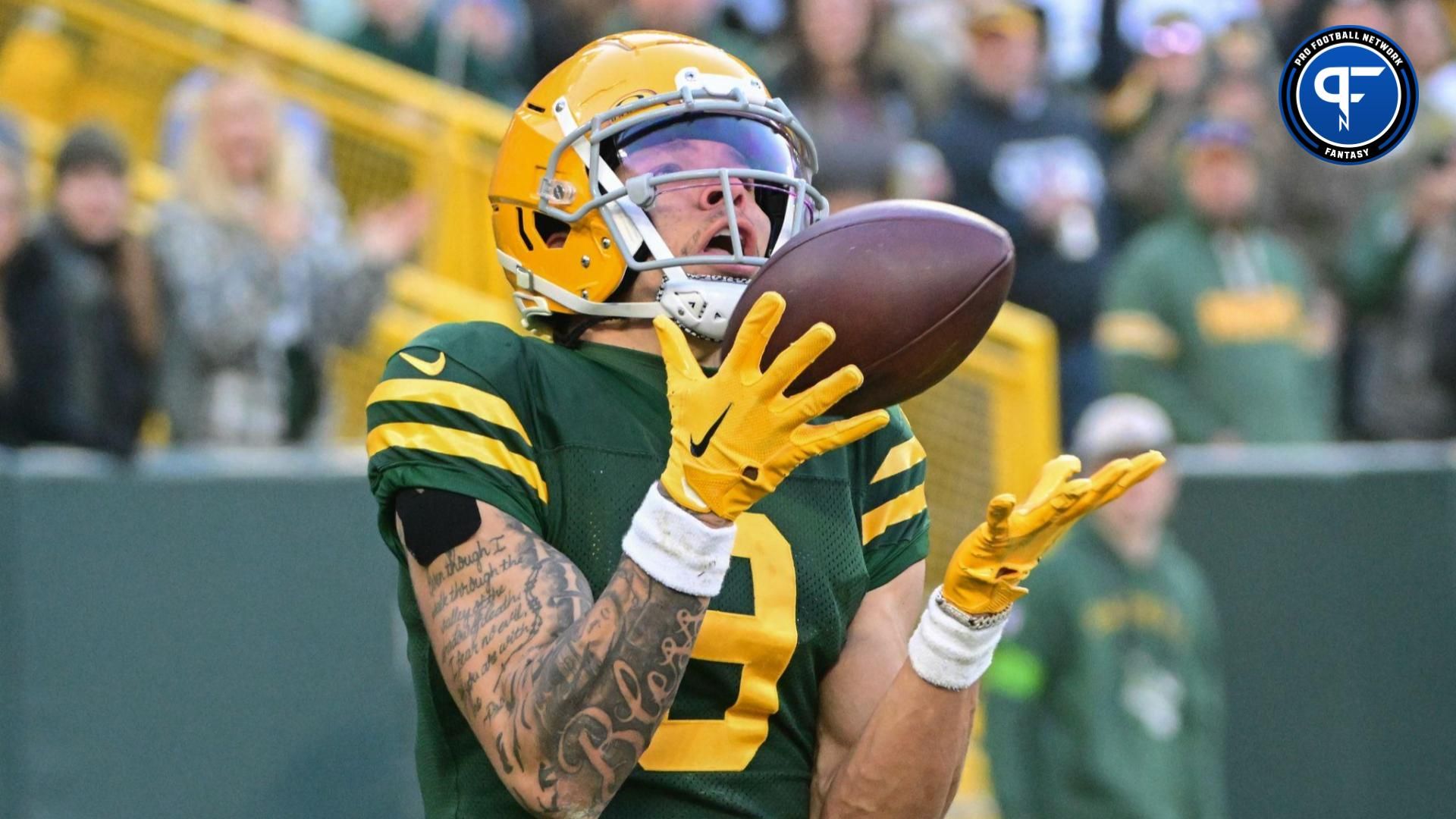 Green Bay Packers wide receiver Christian Watson (9) catches a pass in the end zone for a touchdown in the third quarter against the Los Angeles Chargers at Lambeau Field.