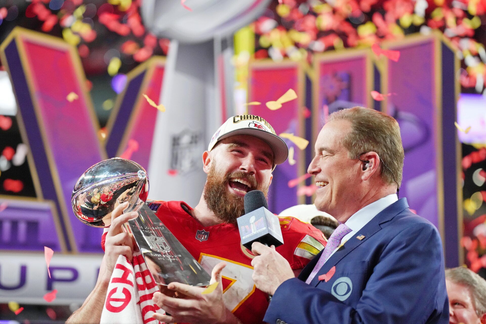 Kansas City Chiefs tight end Travis Kelce (87) celebrates while being interviewed by CBS commentator Jim Nantz after winning Super Bowl LVIII against the San Francisco 49ers at Allegiant Stadium.