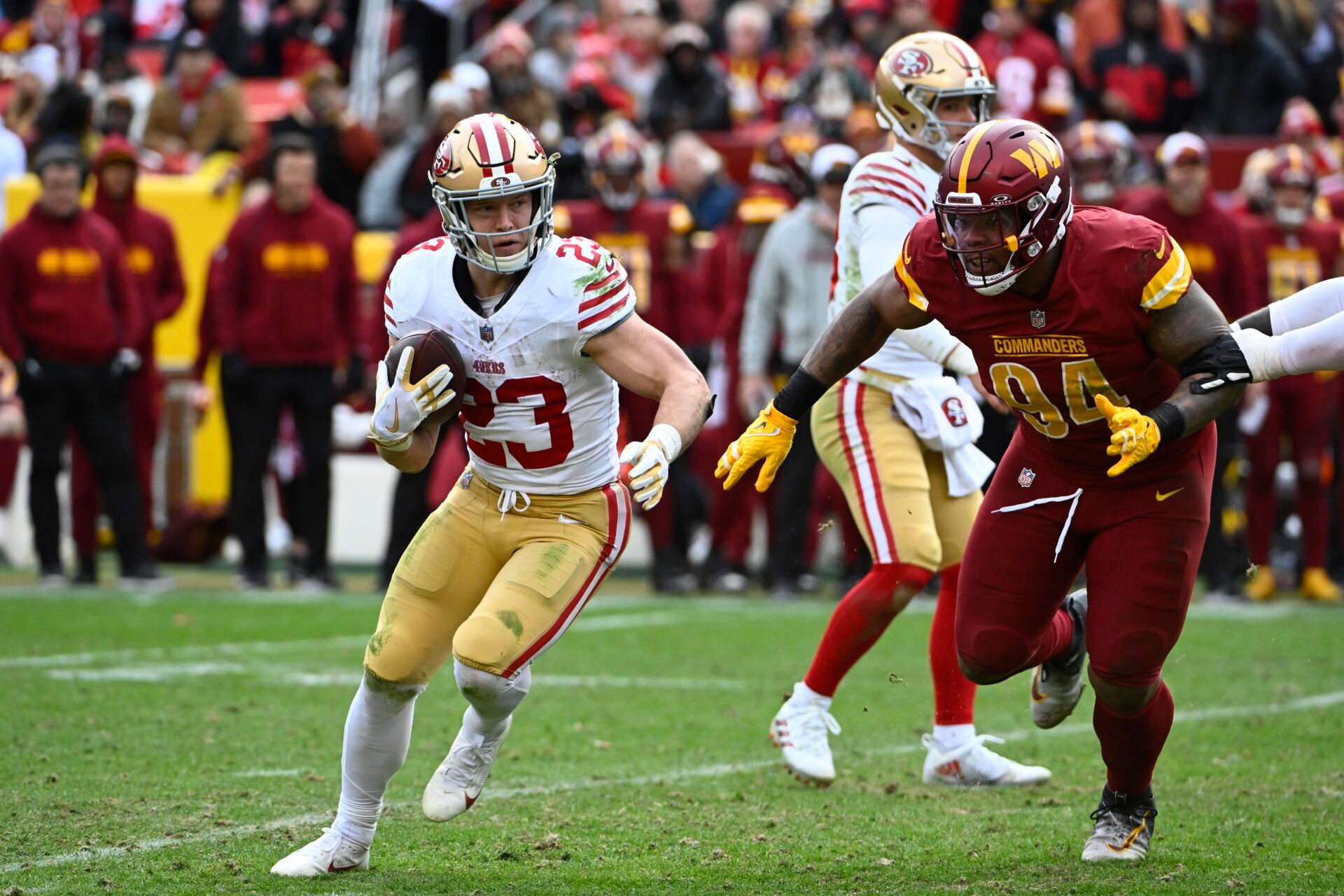 San Francisco 49ers running back Christian McCaffrey (23) carries the ball as Washington Commanders defensive tackle Daron Payne (94) during the second half at FedExField.