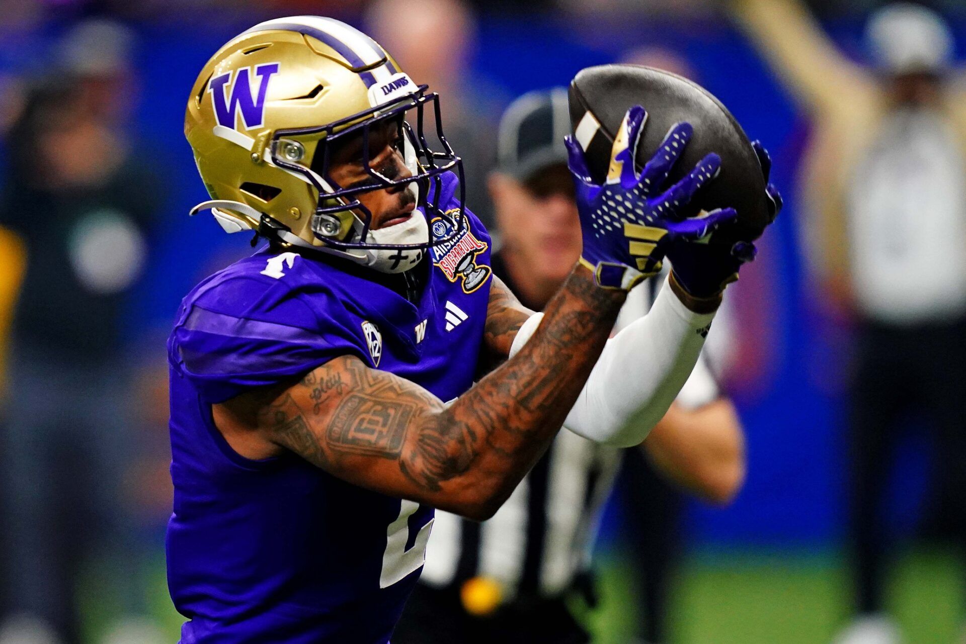 Washington Huskies wide receiver Ja'Lynn Polk (2) catches a touchdown pass during the second quarter against the Texas Longhorns in the 2024 Sugar Bowl college football playoff semifinal game at Caesars Superdome.