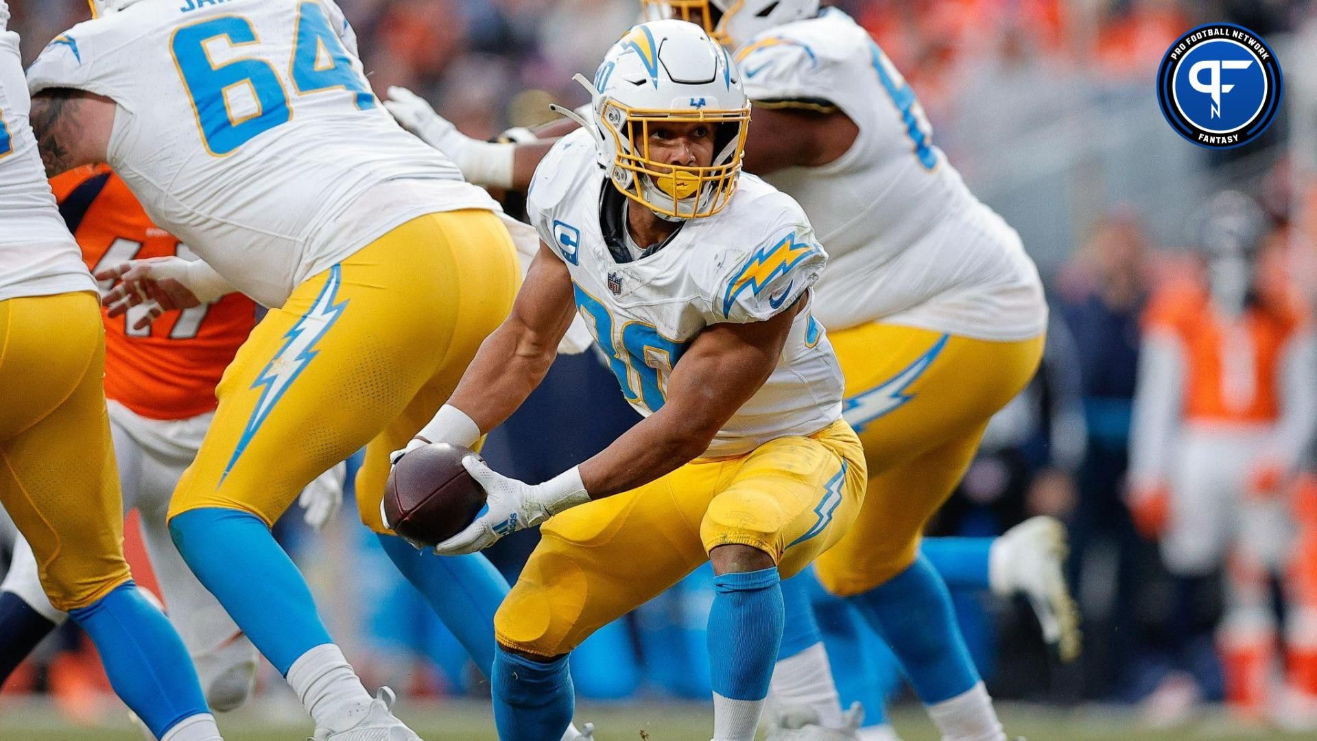 Los Angeles Chargers running back Austin Ekeler (30) pitches the ball in the third quarter against the Denver Broncos at Empower Field at Mile High.