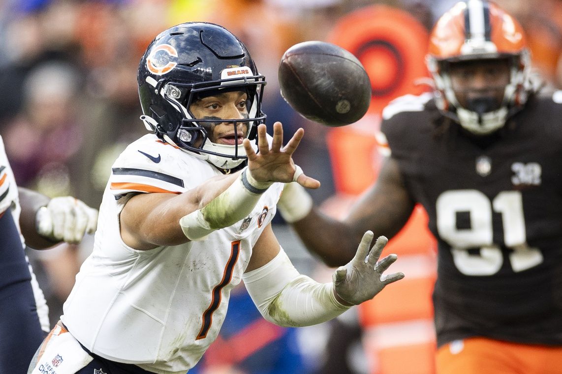 Chicago Bears quarterback Justin Fields (1) tosses the ball to a running back during the fourth quarter against the Cleveland Browns at Cleveland Browns Stadium.