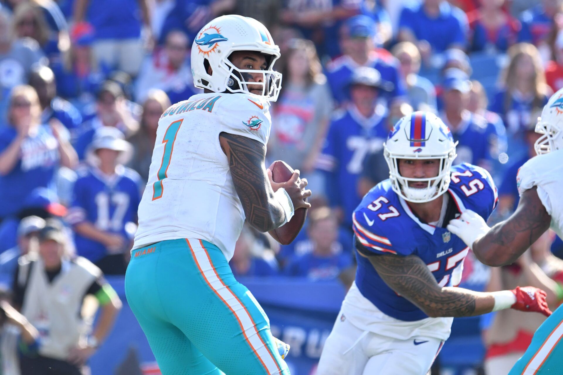 Miami Dolphins quarterback Tua Tagovailoa (1) looks to throw a pass as Buffalo Bills defensive end AJ Epenesa (57) rushes in during the fourth quarter at Highmark Stadium.