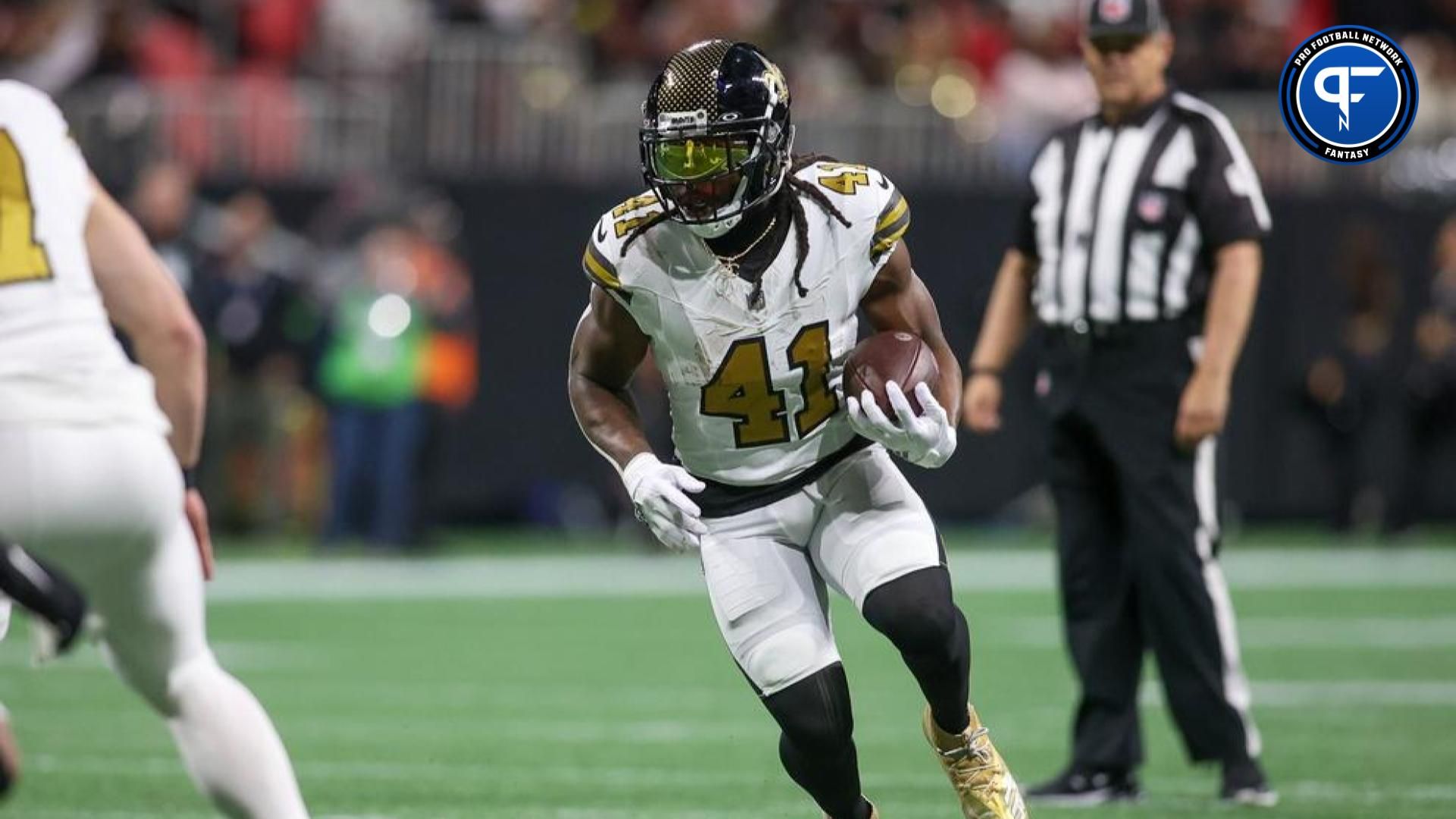 New Orleans Saints running back Alvin Kamara (41) runs the ball against the Atlanta Falcons in the first quarter at Mercedes-Benz Stadium.