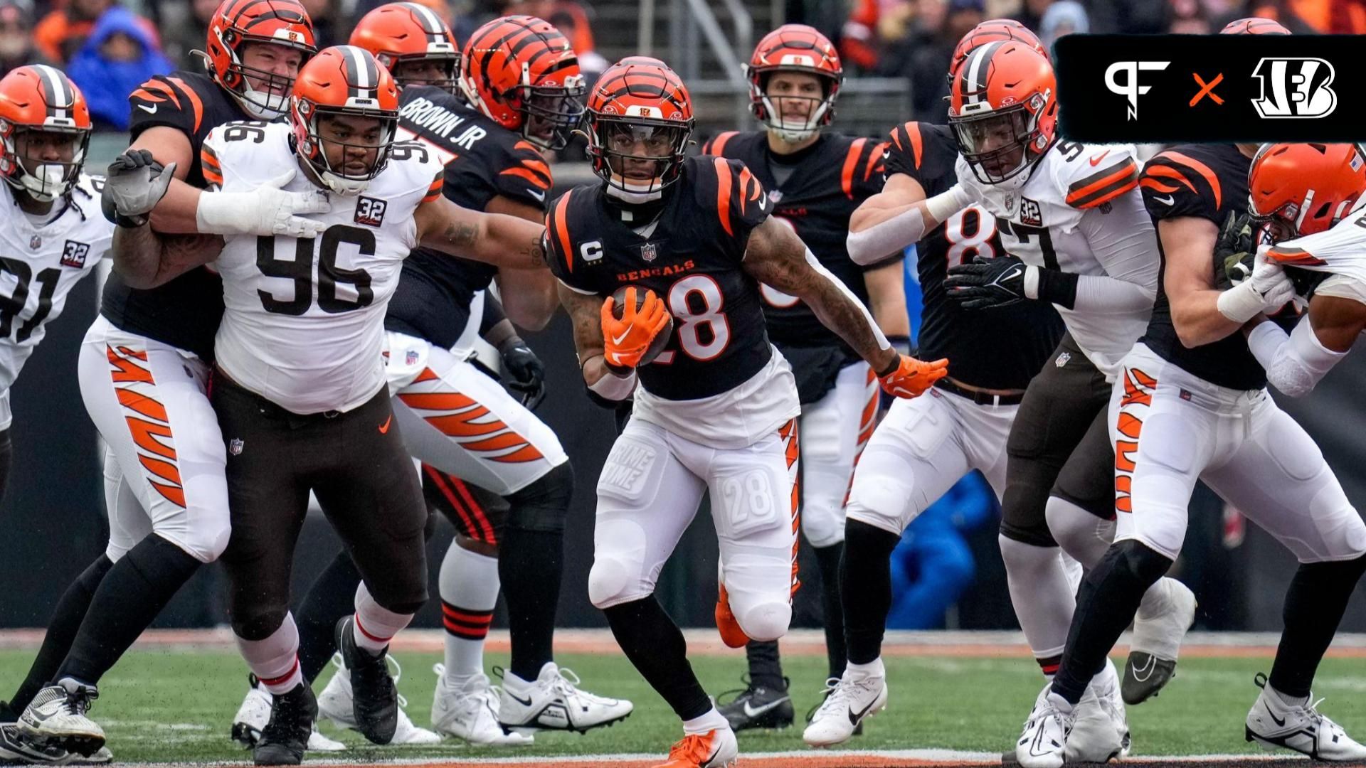 Cincinnati Bengals running back Joe Mixon (28) breaks through the line on a carry in the first quarter of the NFL Week 18 game between the Cincinnati Bengals and the Cleveland Browns at Paycor Stadium in downtown Cincinnati on Sunday, Jan. 7, 2024.