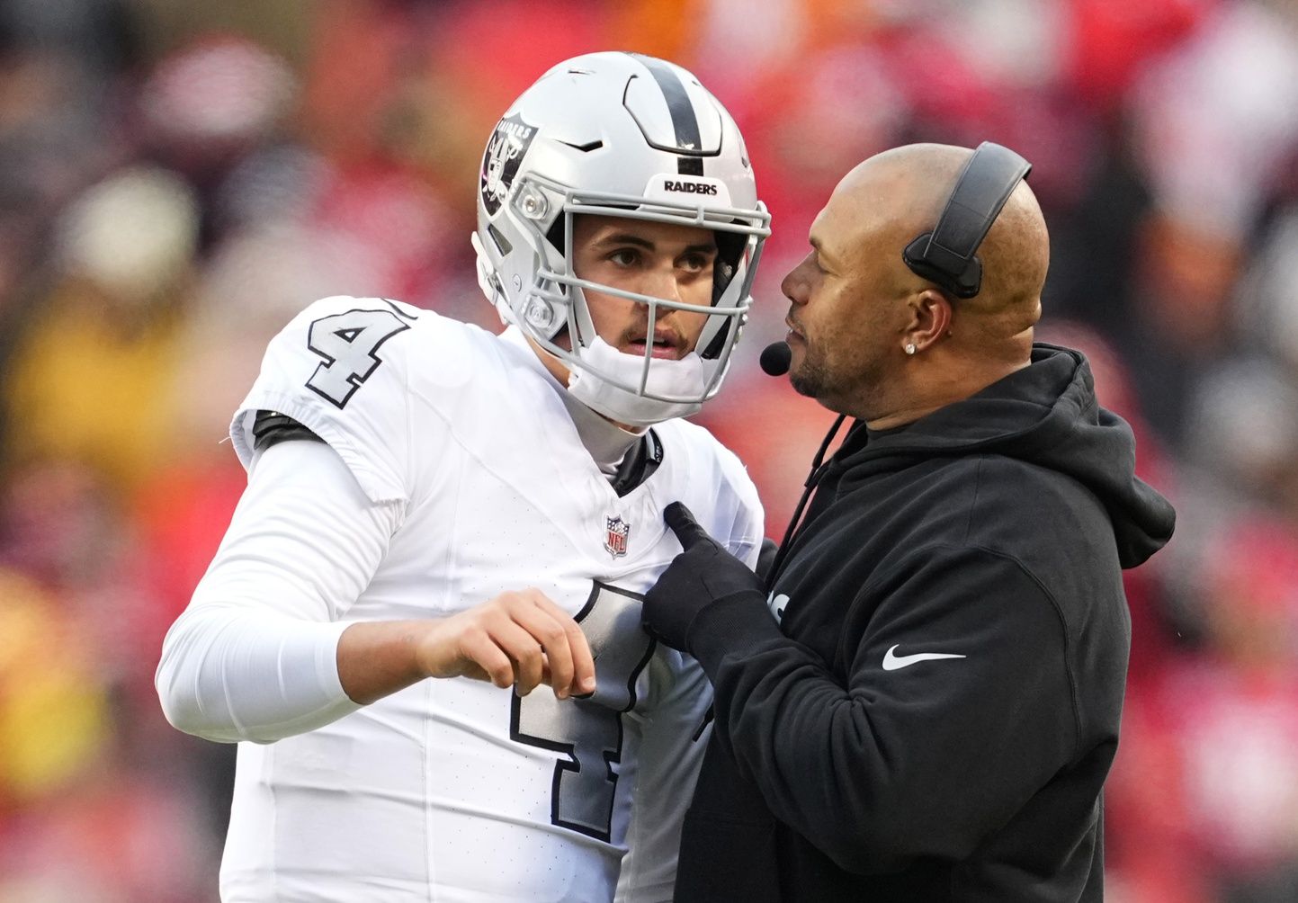 Las Vegas Raiders quarterback Aidan O'Connell (4) talks with head coach Antonio Pierce during the second half against the Las Vegas Raiders at GEHA Field at Arrowhead Stadium.