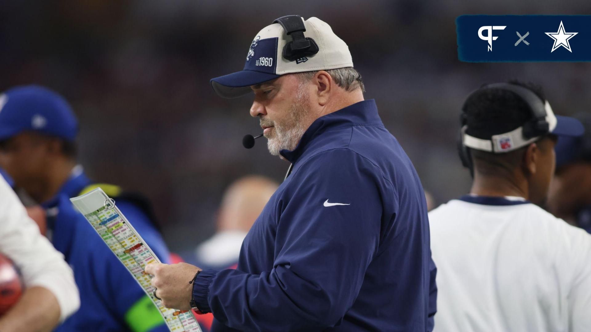 Dallas Cowboys Mike McCarthy looks at the play sheet in then first quarter against the Washington Commanders at AT&T Stadium.