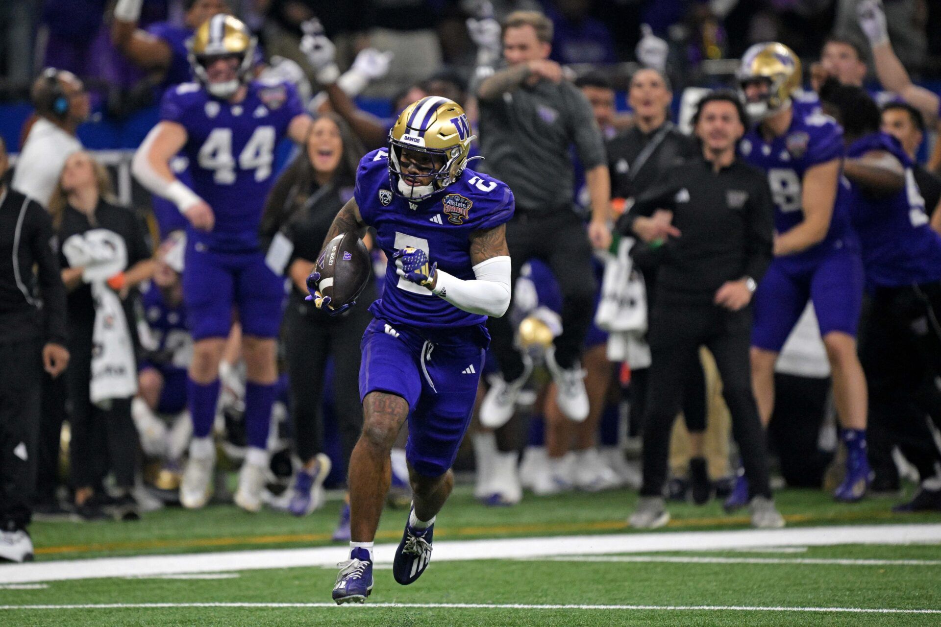 Washington Huskies wide receiver Ja'Lynn Polk (2) runs with the ball after a catch against the Texas Longhorns during the first quarter in the 2024 Sugar Bowl college football playoff semifinal game at Caesars Superdome.