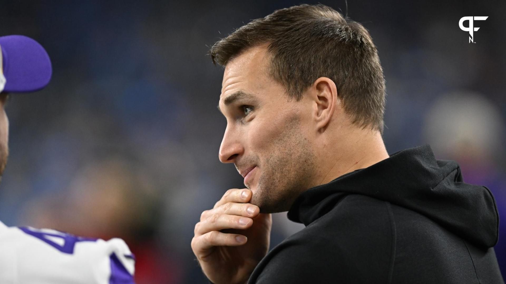 Minnesota Vikings quarterback Kirk Cousins (8) talks with teammates prior to their game against the Detroit Lions at Ford Field.