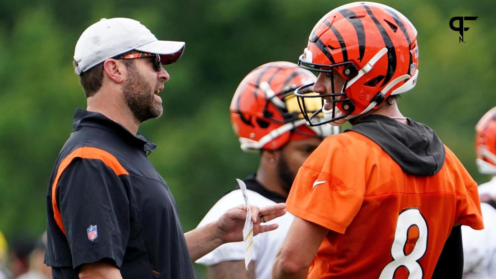 Cincinnati Bengals offensive coordinator Brian Callahan, left, talks with Cincinnati Bengals quarterback Brandon Allen (8), right, during Cincinnati Bengals training camp practice, Monday, Aug. 1, 2022, at the practice fields next to Paul Brown Stadium in Cincinnati.