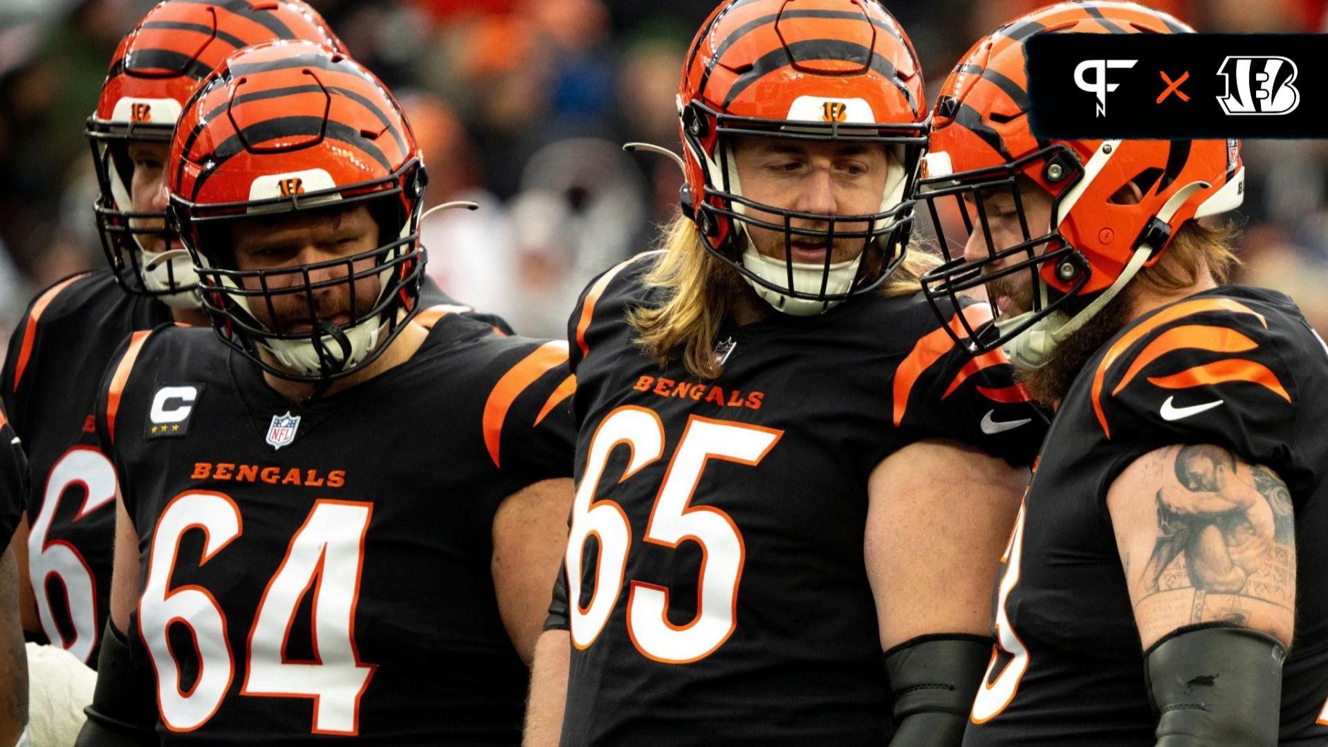 Cincinnati Bengals offensive linemen talk during a game.